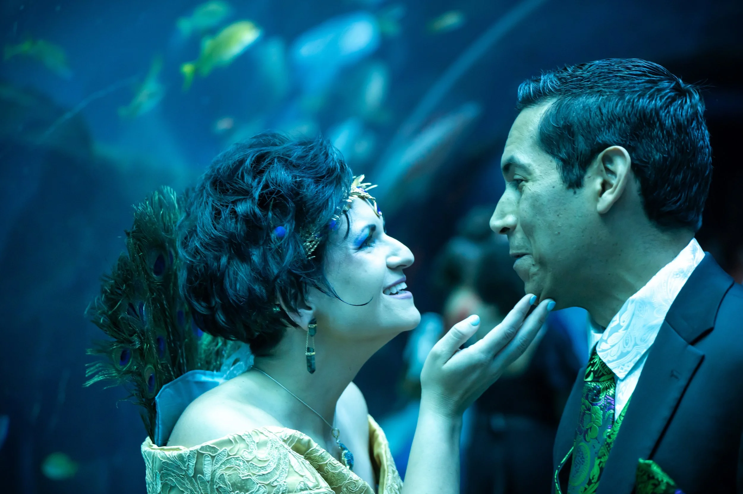 Couple smiling in front of aquarium tank