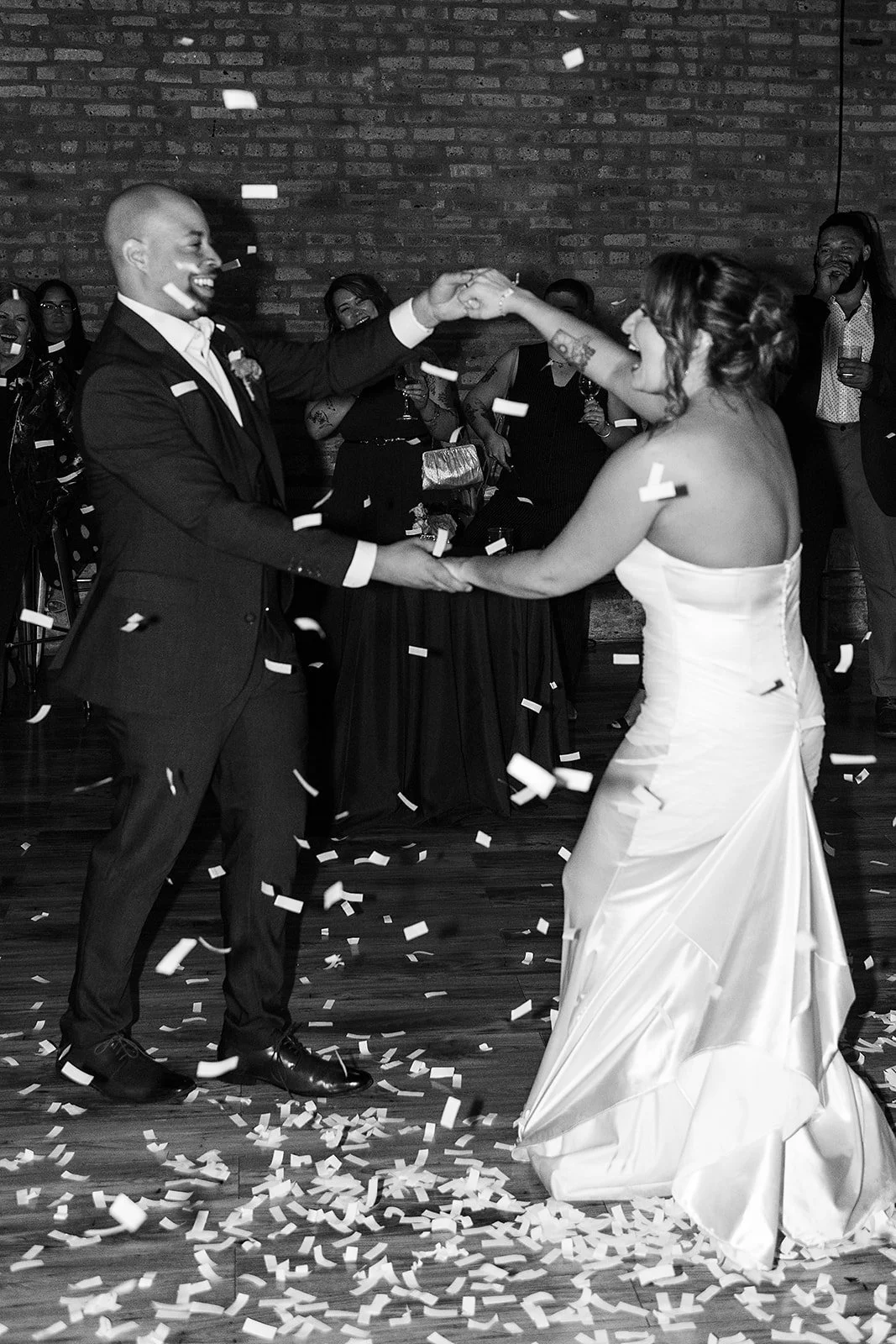 Bride and groom dancing in confetti at editorial wedding