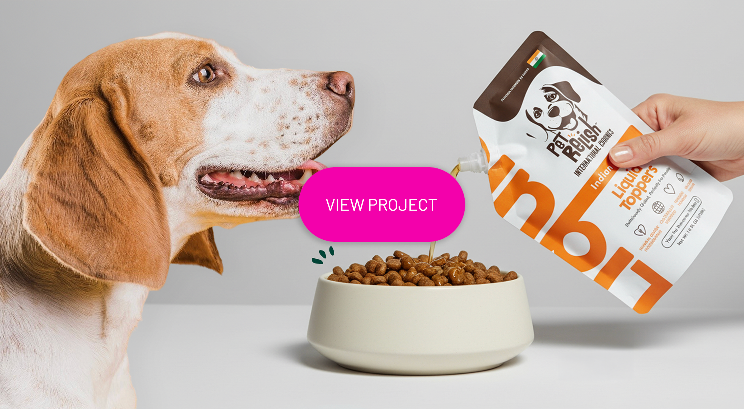 A dog being fed dry dog food from a cow-shaped pouch, with a pink button labeled 'View Project' in the center.