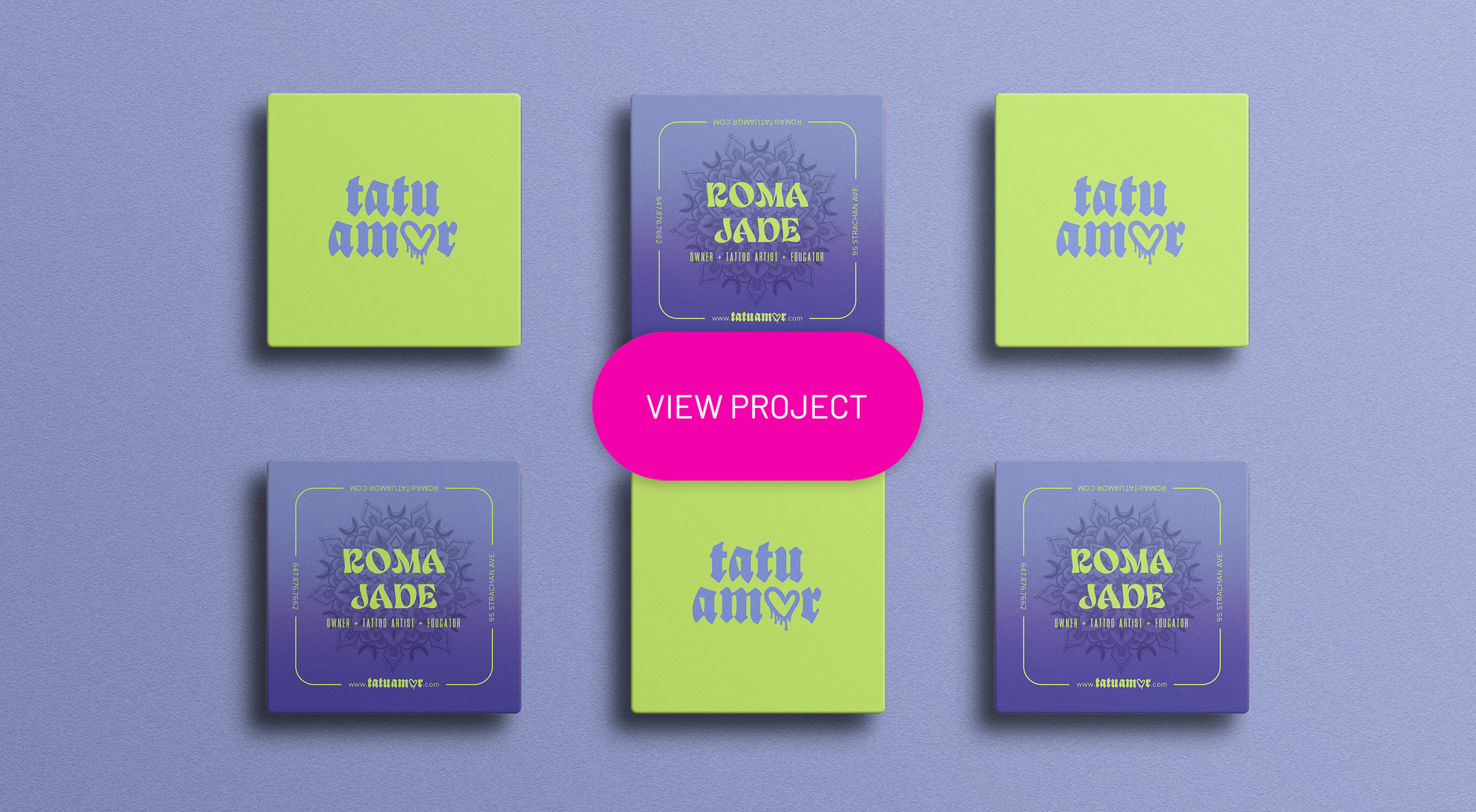 Four green and purple business cards arranged in a diamond shape on a purple surface. The card at the top and bottom are green with blue text that says "tatu amour" with a small heart. The left and right cards are purple with a floral design and green text that says "ROMA JADE OWNER + TATTOO ARTIST + EDUCATOR" and the website "www.tatuamour.com". In the center is a pink button with white text that says "VIEW PROJECT."