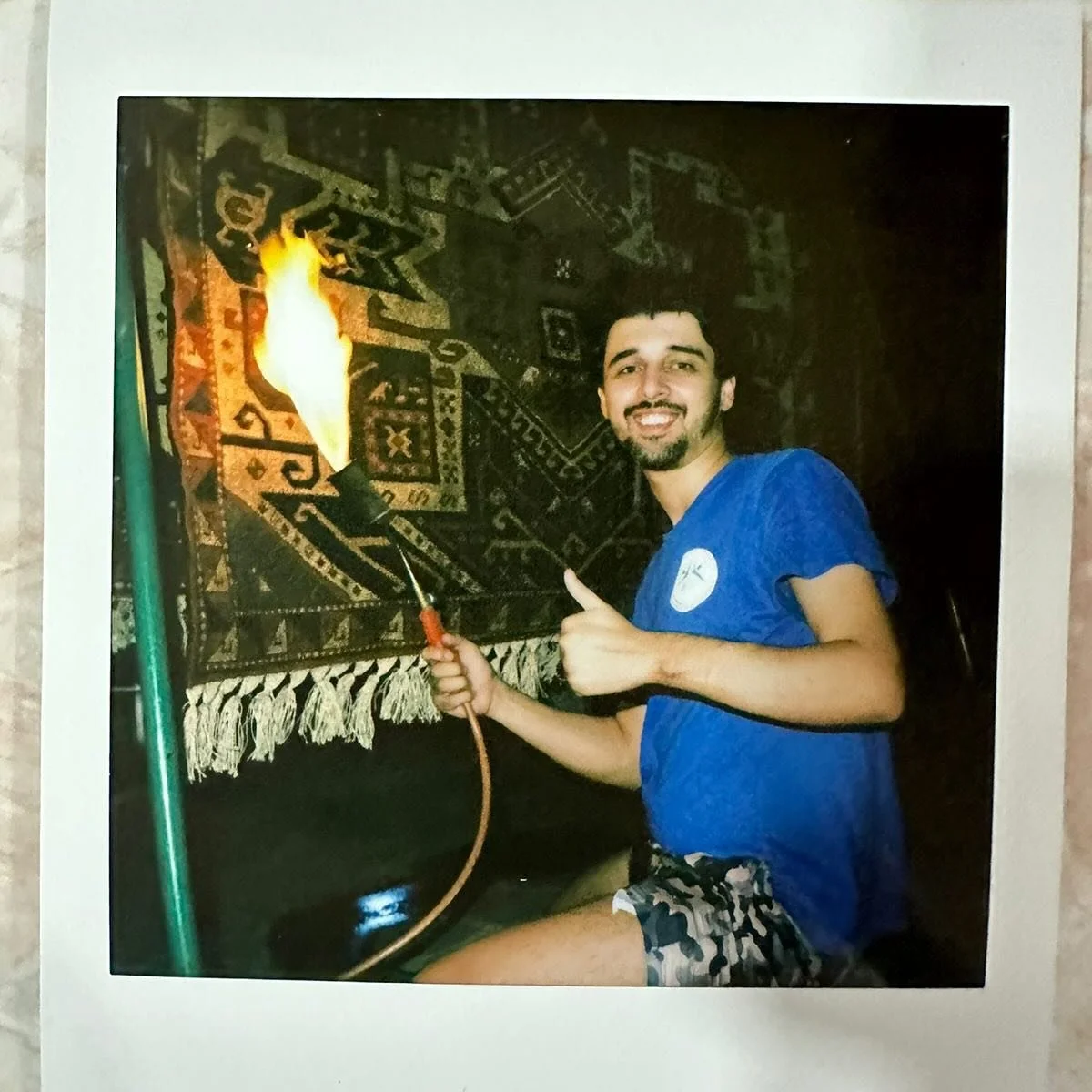 We burn the backs of our rugs with a blowtorch, removing fluff that collects as the rug is woven. Zaur burns a new Star Kazak woven by Sevda in Kosalar. All our rugs copy antique designs from this region, this is the first time we have woven this par
