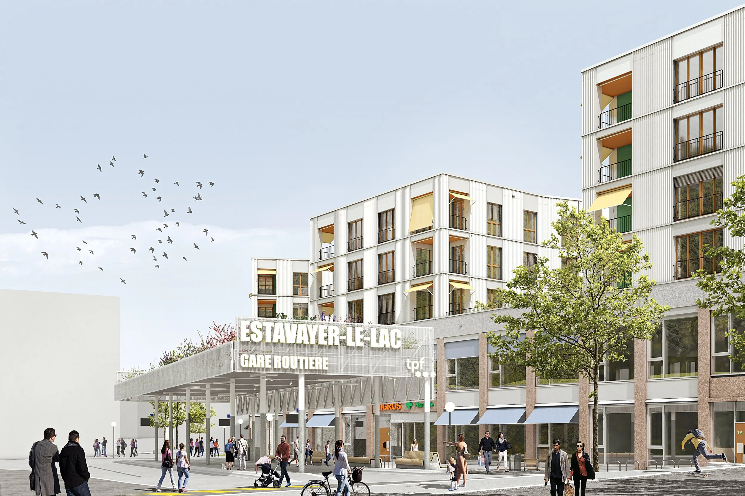 Entrée de la gare routière Estavayer-le-Lac avec des bâtiments modernes, des arbres et des personnes marchant dans la rue.