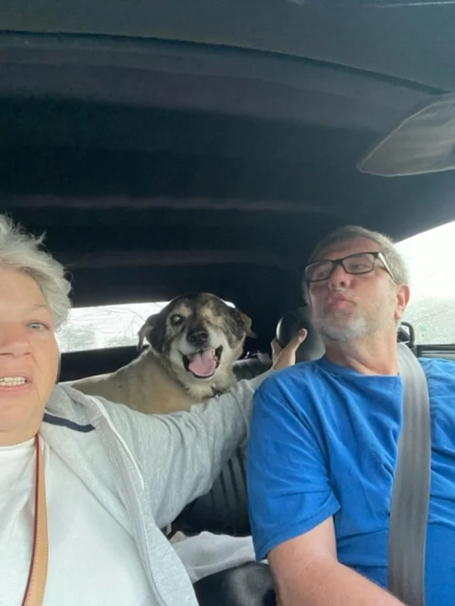 Judy and Len Garrison in the car with their dog