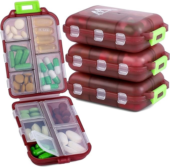 Stacked red plastic pillboxes with green latches, open containers showing assorted pills and capsules in various colors and sizes.