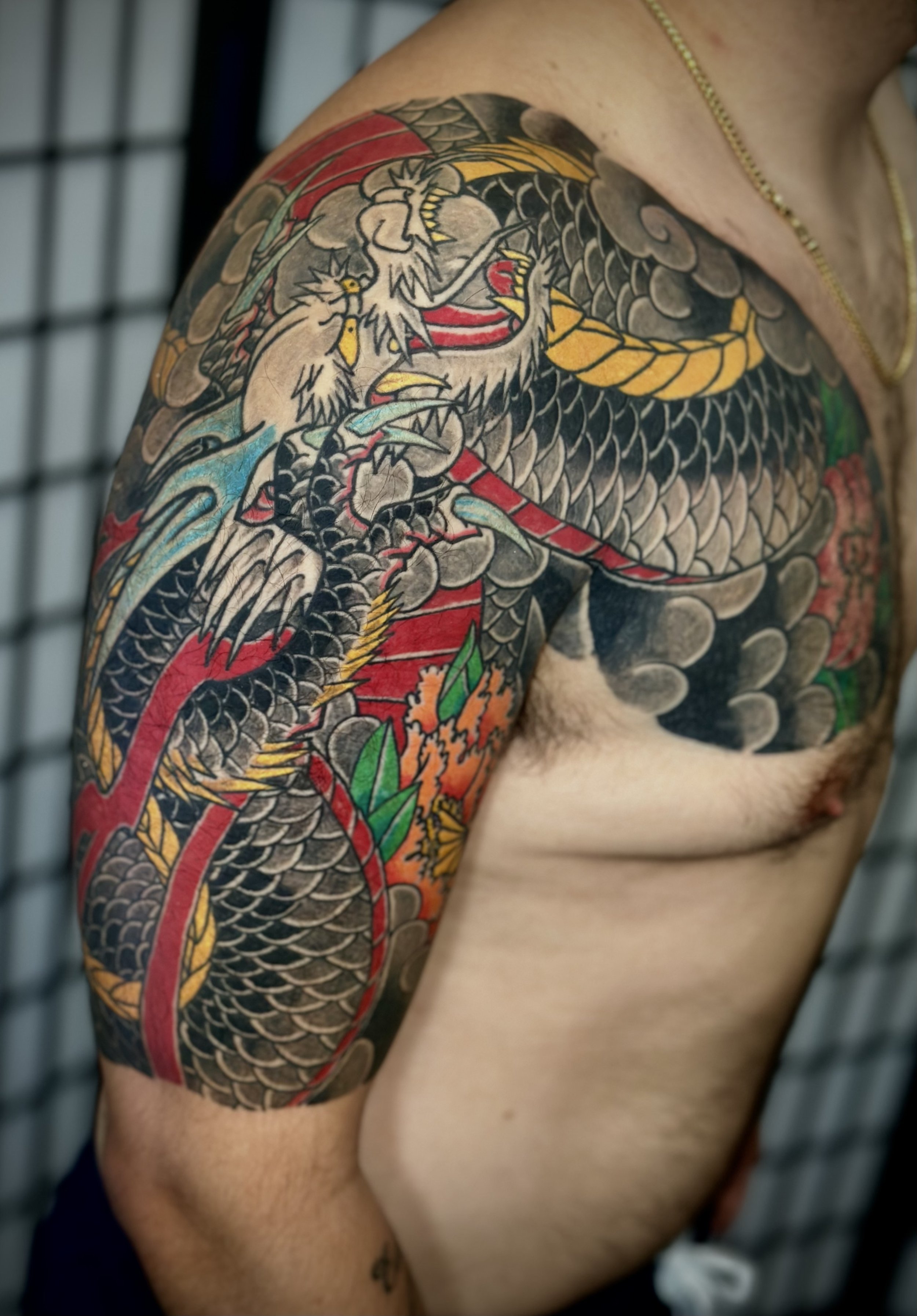 Dragon & Peony Japanese Tattoo — Half Sleeve, Fort Lauderdale | A half sleeve featuring a dragon with peonies. Outline by machine; all shading and color applied by hand using tebori. Healed.