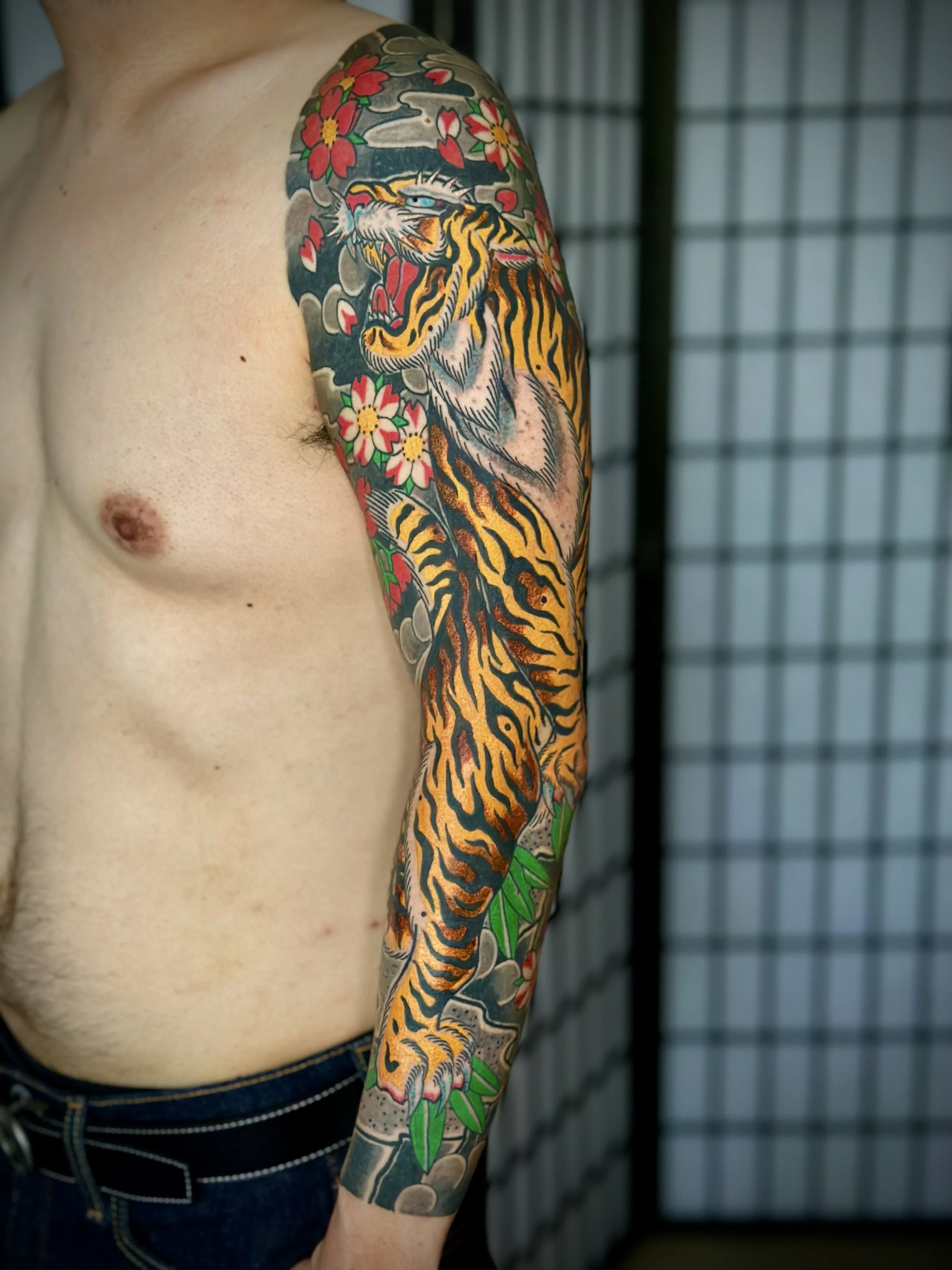Tiger & Cherry Blossom Japanese Tattoo — Full Sleeve, Fort Lauderdale | Traditional Japanese full sleeve featuring a tiger with cherry blossoms and clouds. Outline by machine; all shading and color applied by hand using tebori. Healed