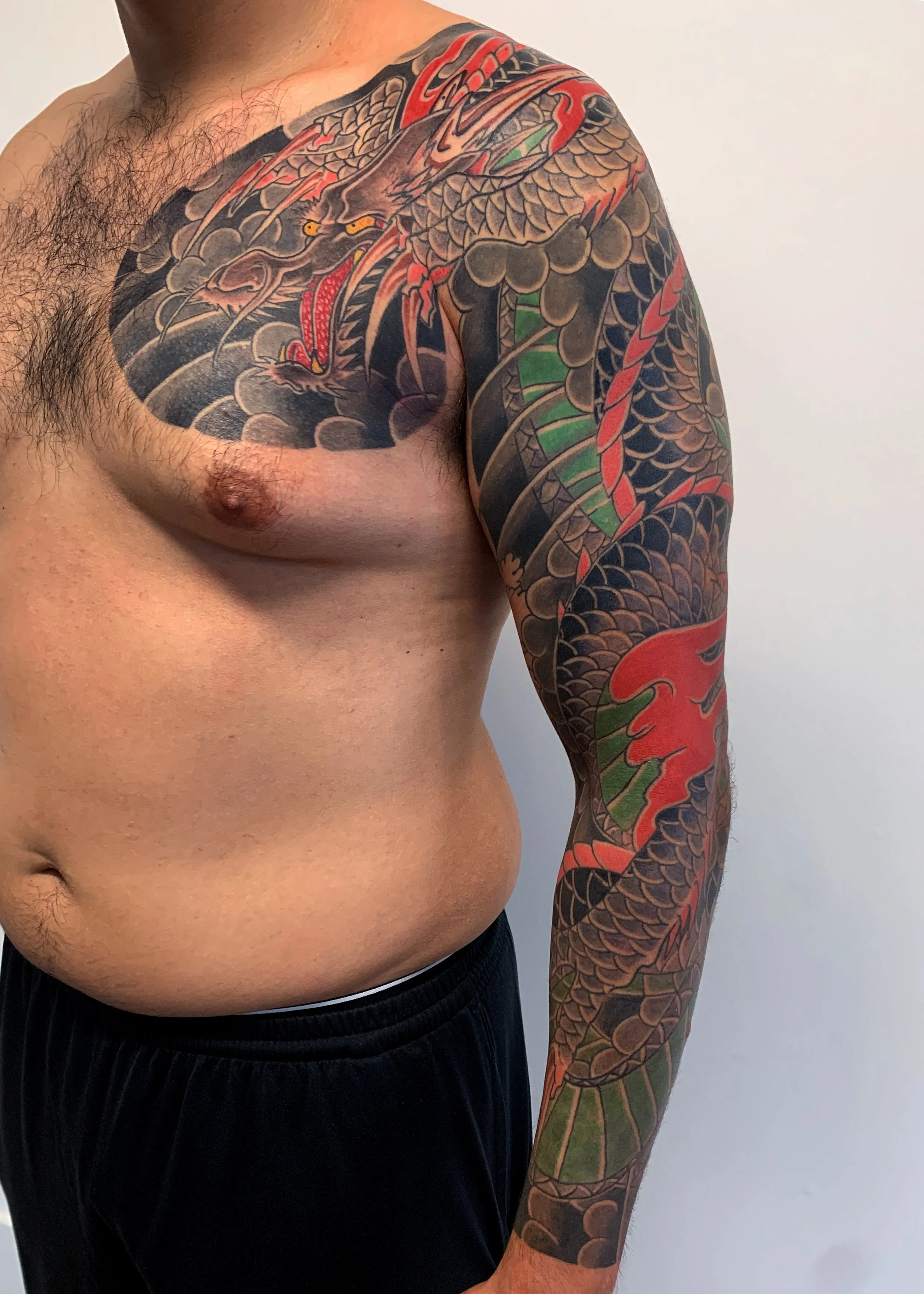 Dragon Japanese Tattoo — Full Sleeve & Chest Panel, Freehand, Fort Lauderdale | A freehand full sleeve and chest panel dragon. Outline by machine; color applied by hand using tebori. Healed.