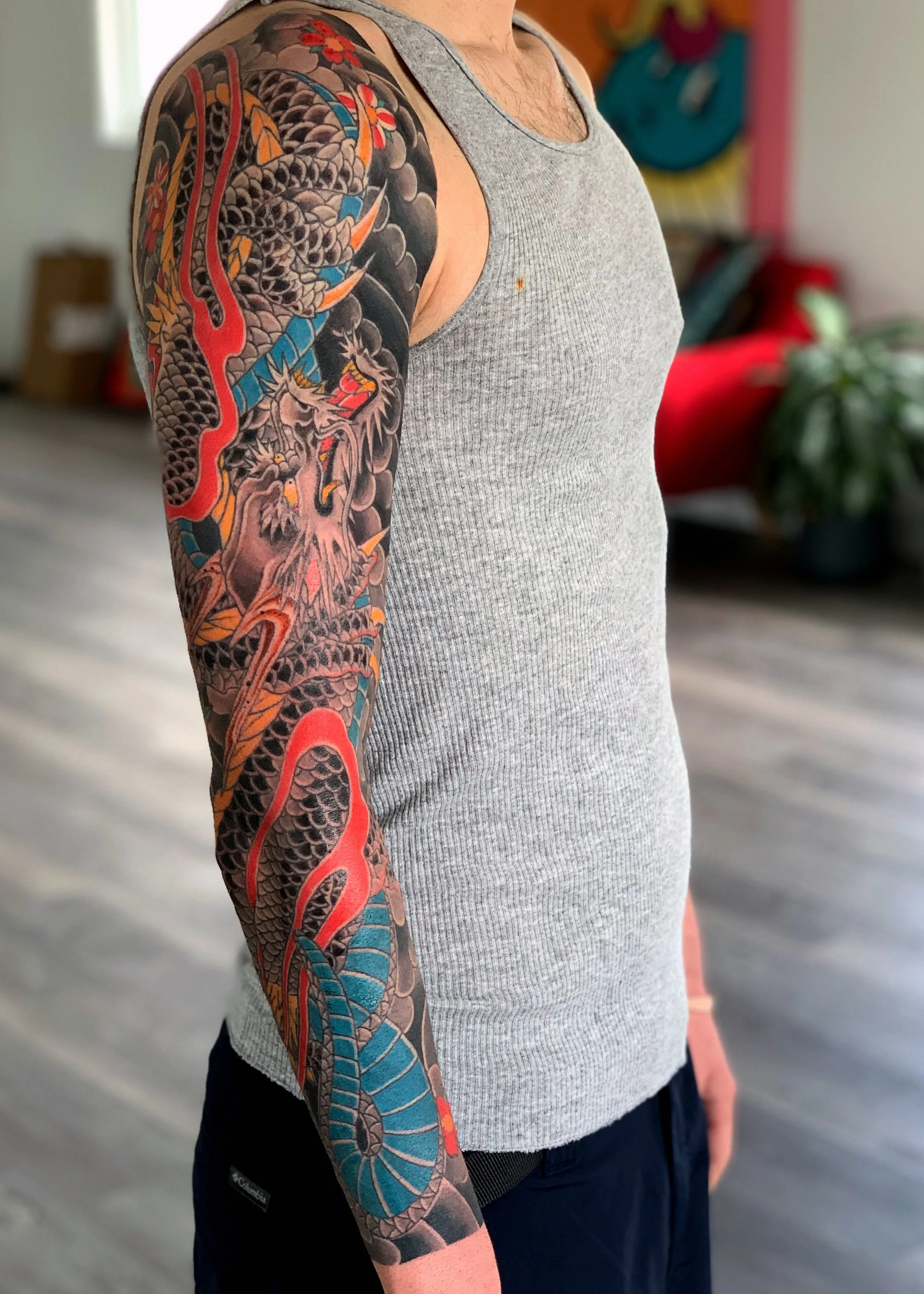 Dragon & Flame Japanese Tattoo — Full Sleeve, Fort Lauderdale | A full sleeve featuring a dragon with flames and cherry blossoms. Entirely machine work. Healed.