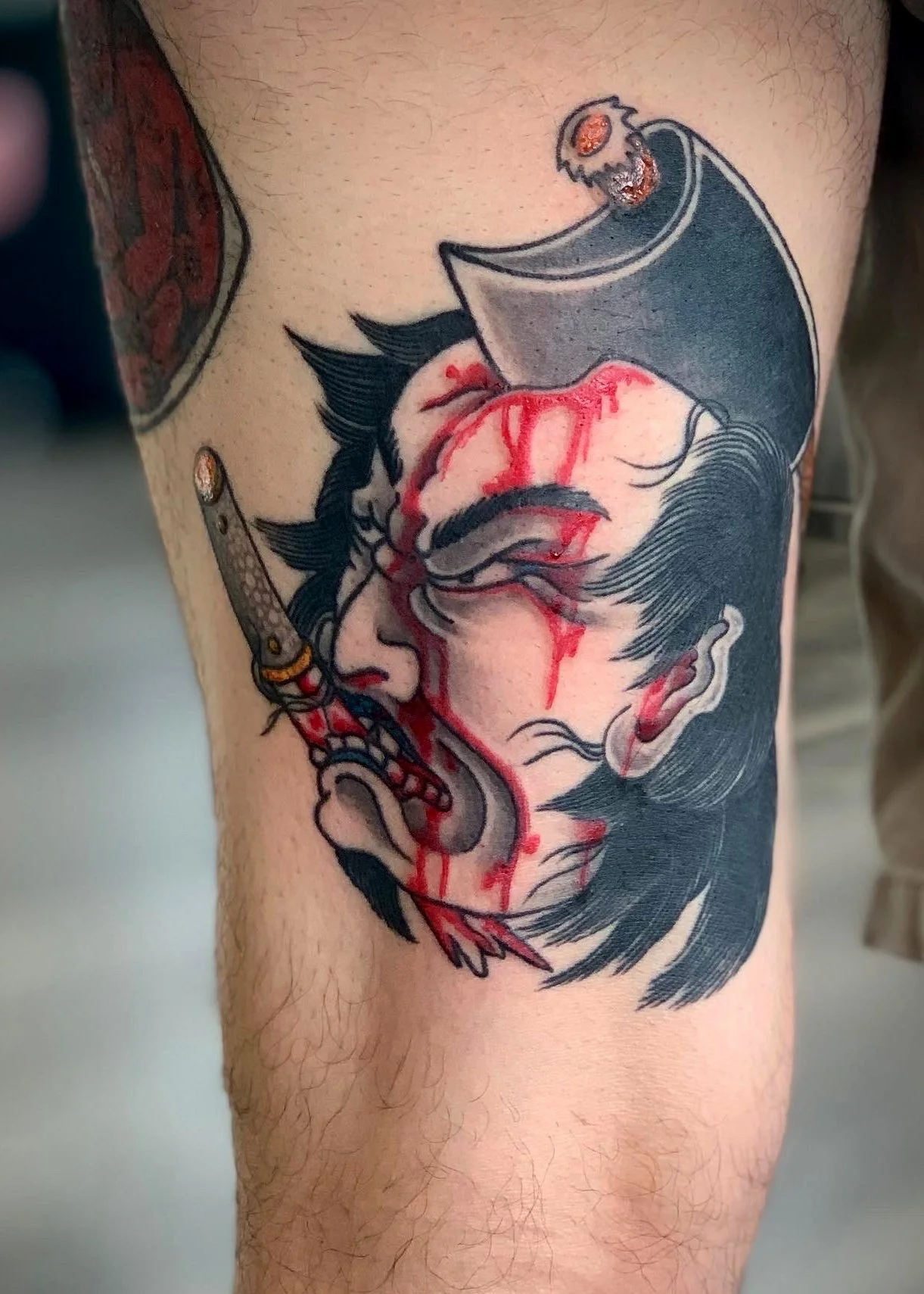 Namakubi Japanese Tattoo — Back of Thigh, Fort Lauderdale | A namakubi (severed head) tattoo depicting a warrior figure with a blade. Entirely machine work. Healed.