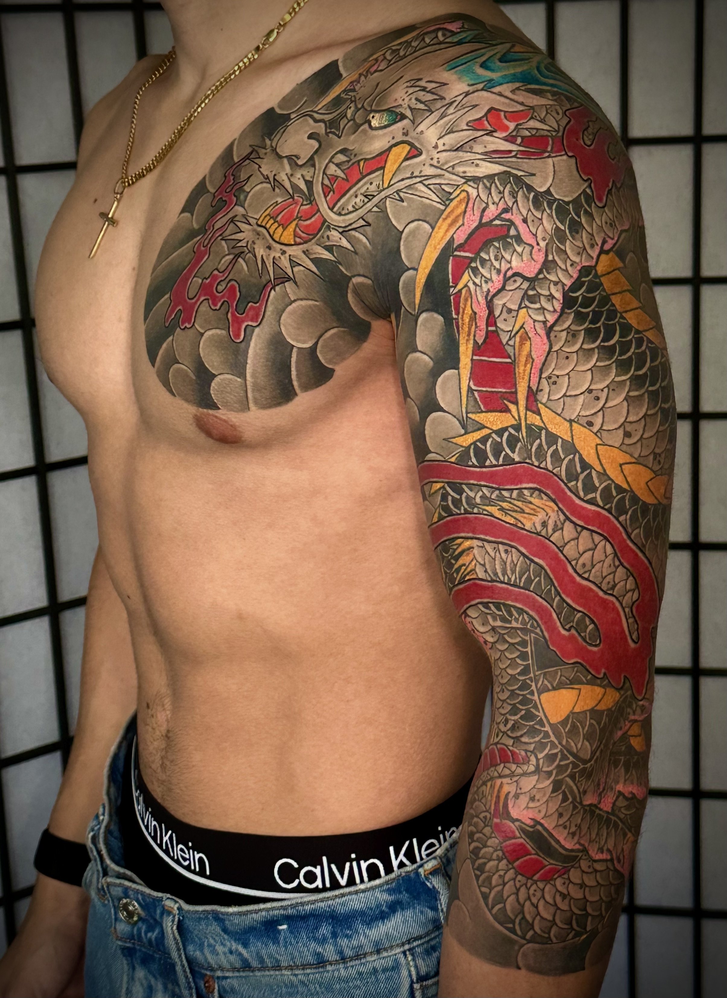 Dragon Japanese Tattoo — Three-Quarter Sleeve & Chest Panel, Fort Lauderdale | Japanese dragon tattoo spanning a three-quarter sleeve and chest panel. Black-and-grey outline and shading by machine; color applied by hand using tebori. Healed