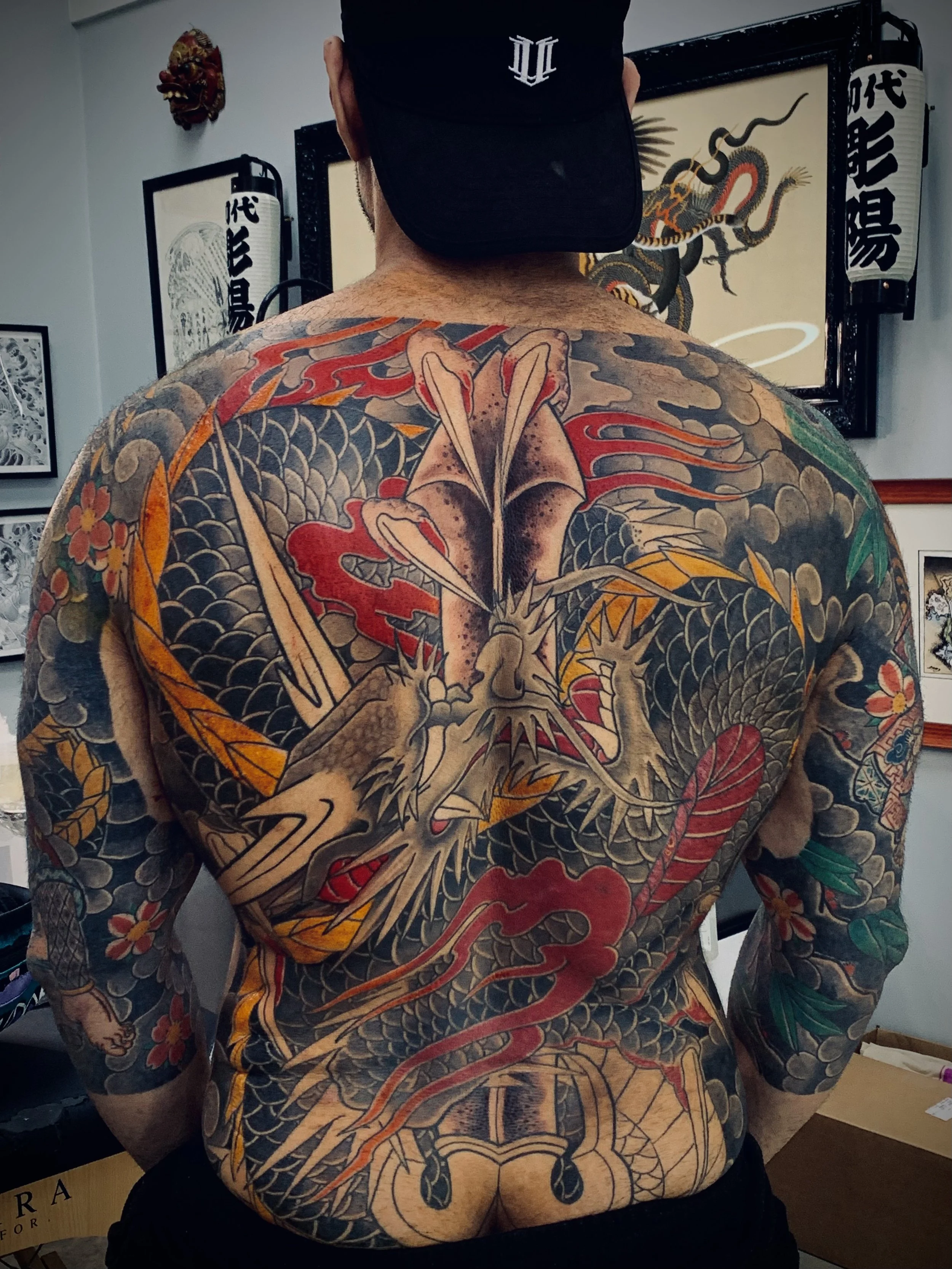 Kurikara Tebori Tattoo — Traditional Kame-no-Koh Back Piece, Fort Lauderdale | A kame-no-koh (turtle-shell) backpiece depicting Kurikara, the dragon entwined around Fudo Myoo's sword in traditional Japanese iconography. Black-and-grey outline and sha