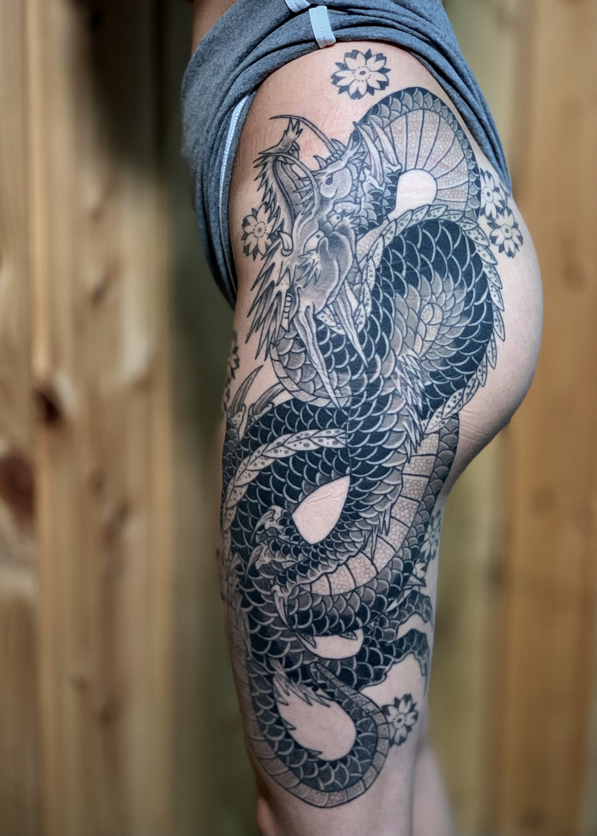 Dragon Japanese Tattoo — Thigh & Glute, Fort Lauderdale | A dragon tattooed across the thigh and buttock in black-and-grey dotwork style. Entirely machine work. Healed.