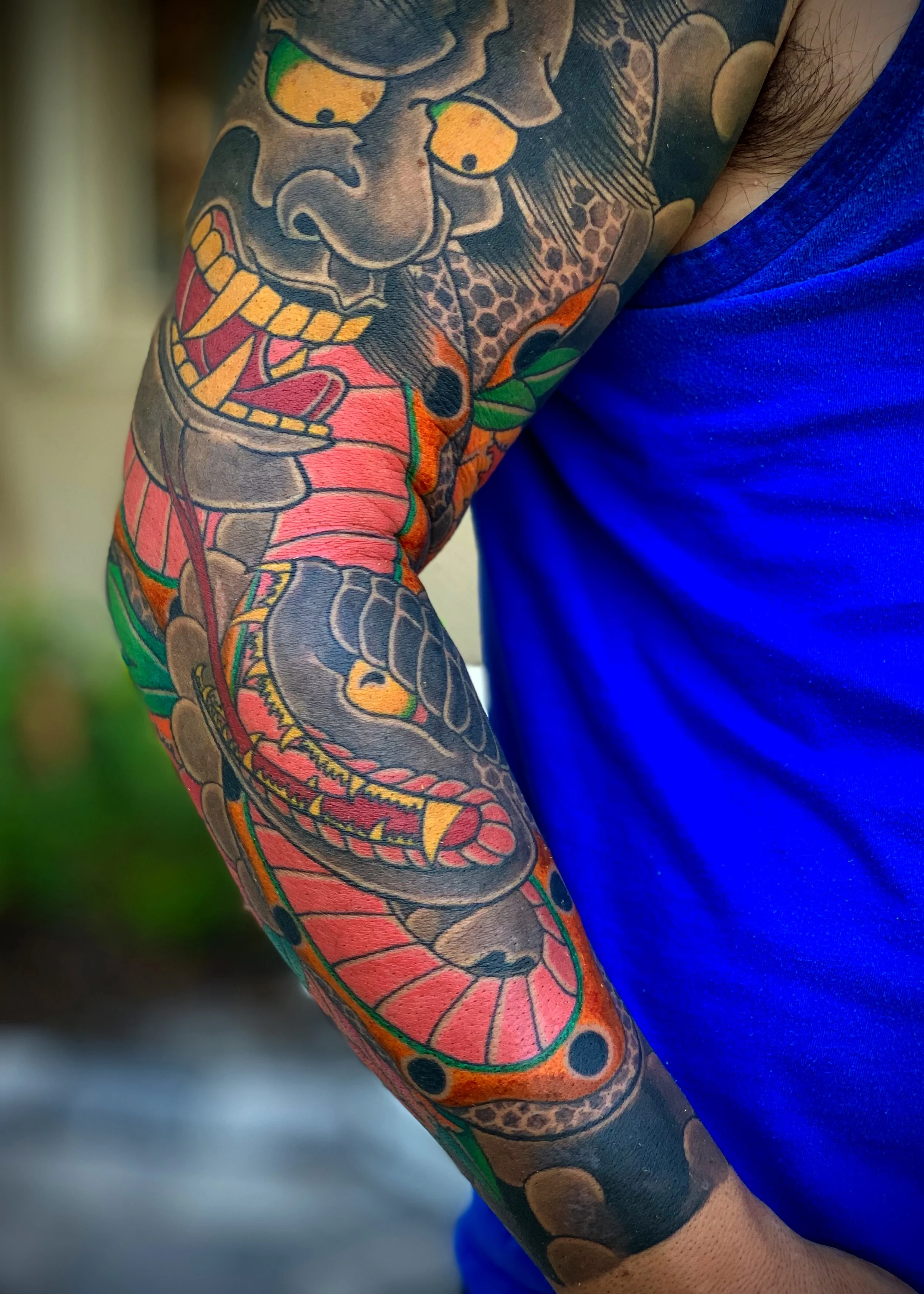 Hannya & Snake Japanese Tattoo — Full Sleeve, Fort Lauderdale | A full sleeve featuring a hannya mask entwined with a snake in warm red and orange tones. Entirely machine work. Healed.