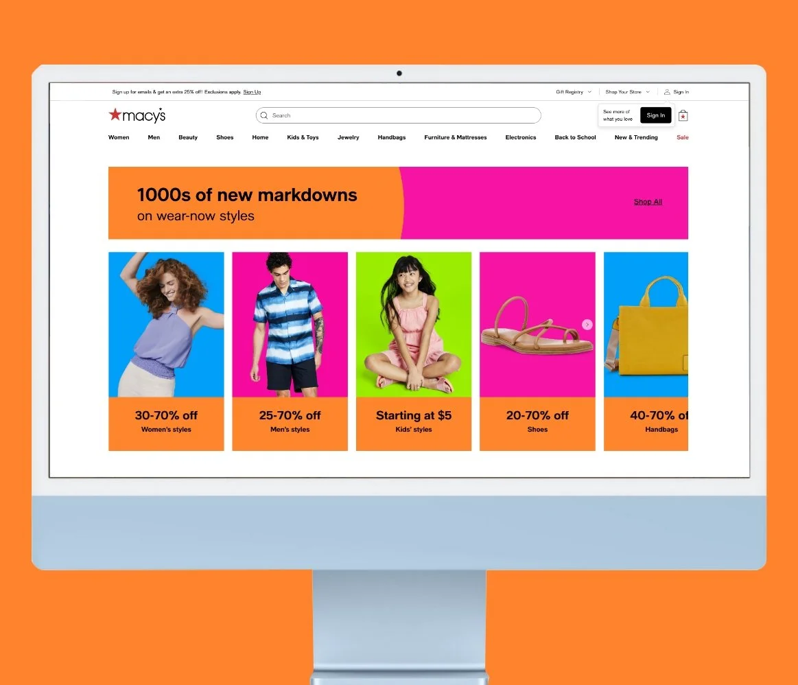 Macy's website displayed on a computer screen showcasing sales on women's, men's, kids' clothing, shoes, handbags, and more.