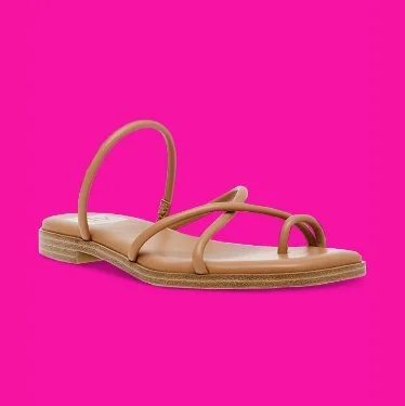 Beige sandal with thin straps on pink background