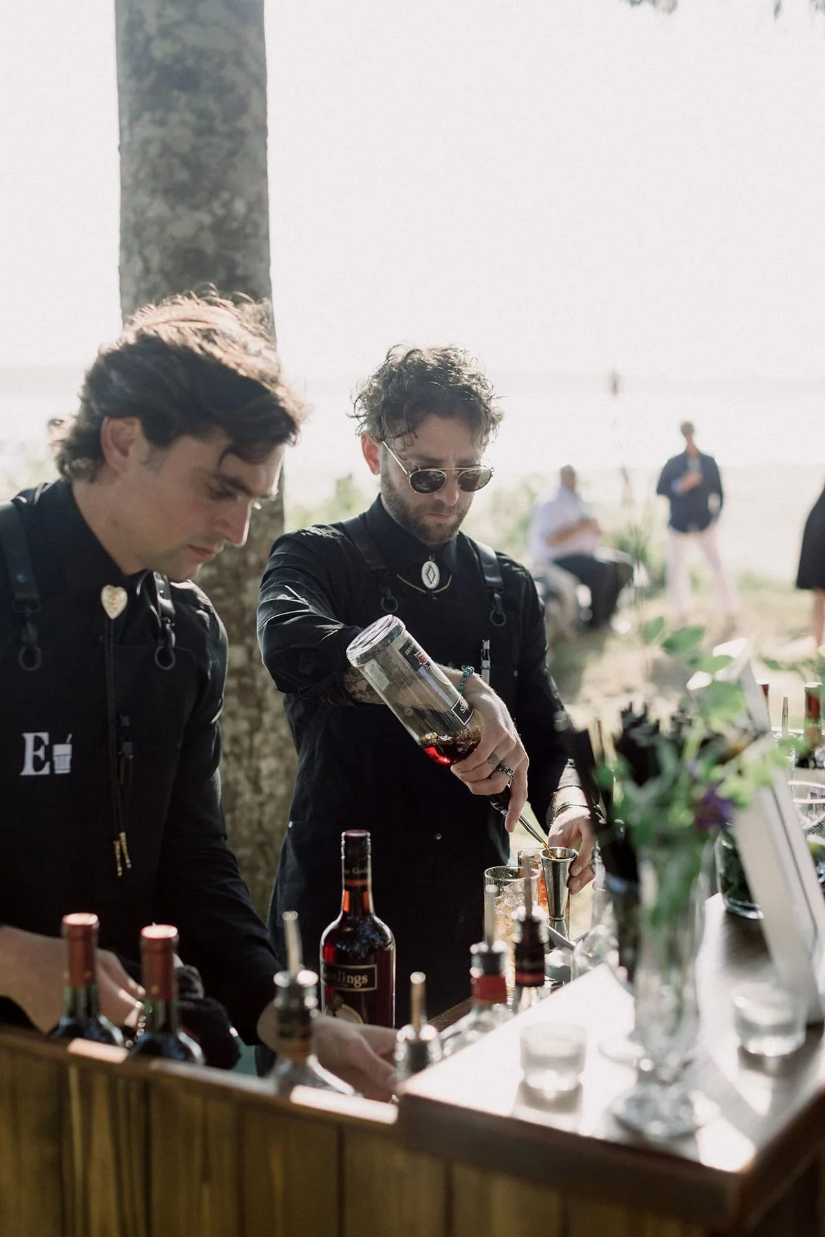 Event bartenders from Evergreen Bar Company preparing cocktails at an outdoor event
