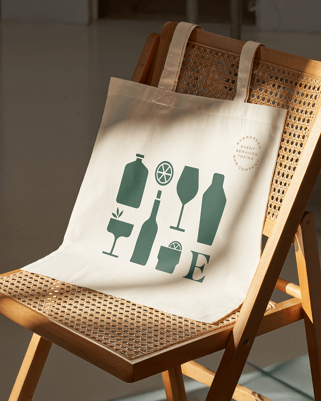 Branded tote bag from Evergreen Bar Company featuring illustrated bar icons