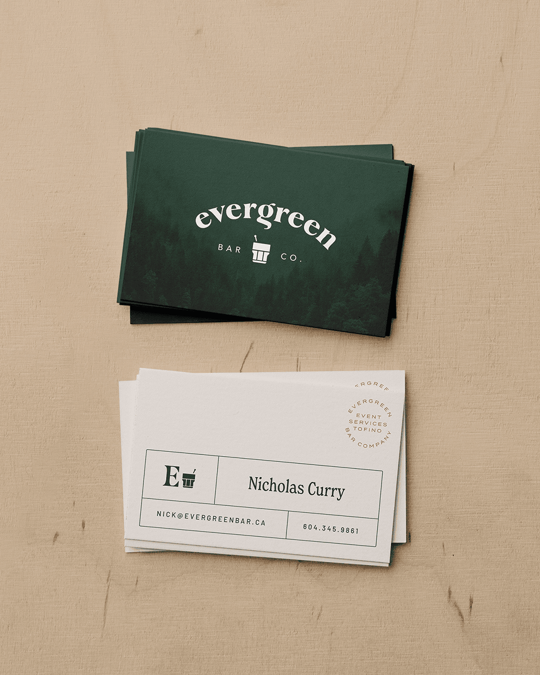 Evergreen Bar Company branded stationery featuring business cards
