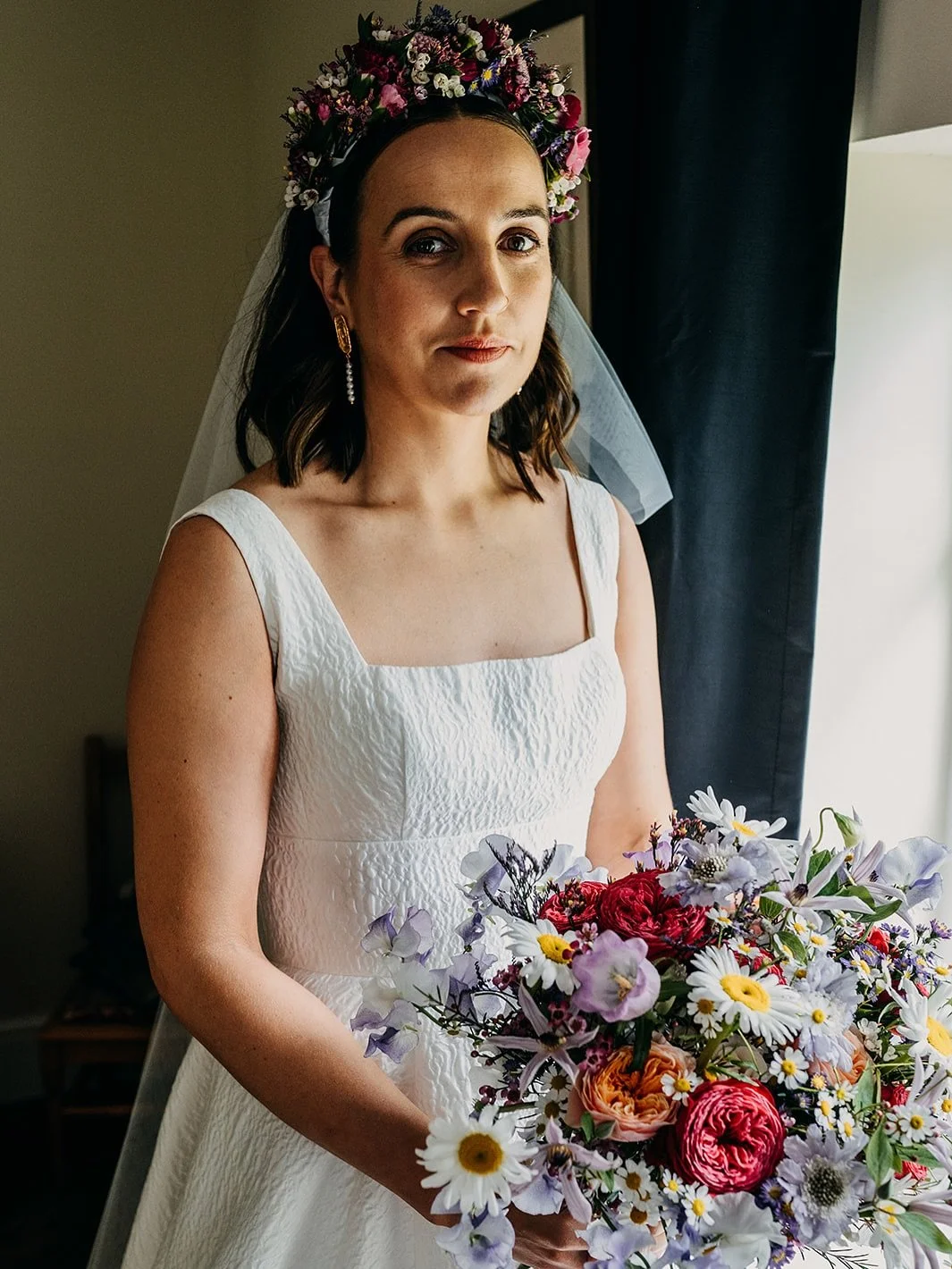 Gorgeous Izzy chose bold, midsummer wedding flowers including a statement floral headband and bouquet. I absolutely loved this vibe. She looked stunning and partied into the night still rocking her headband. Photographer - @kmgs_photography Venue - @