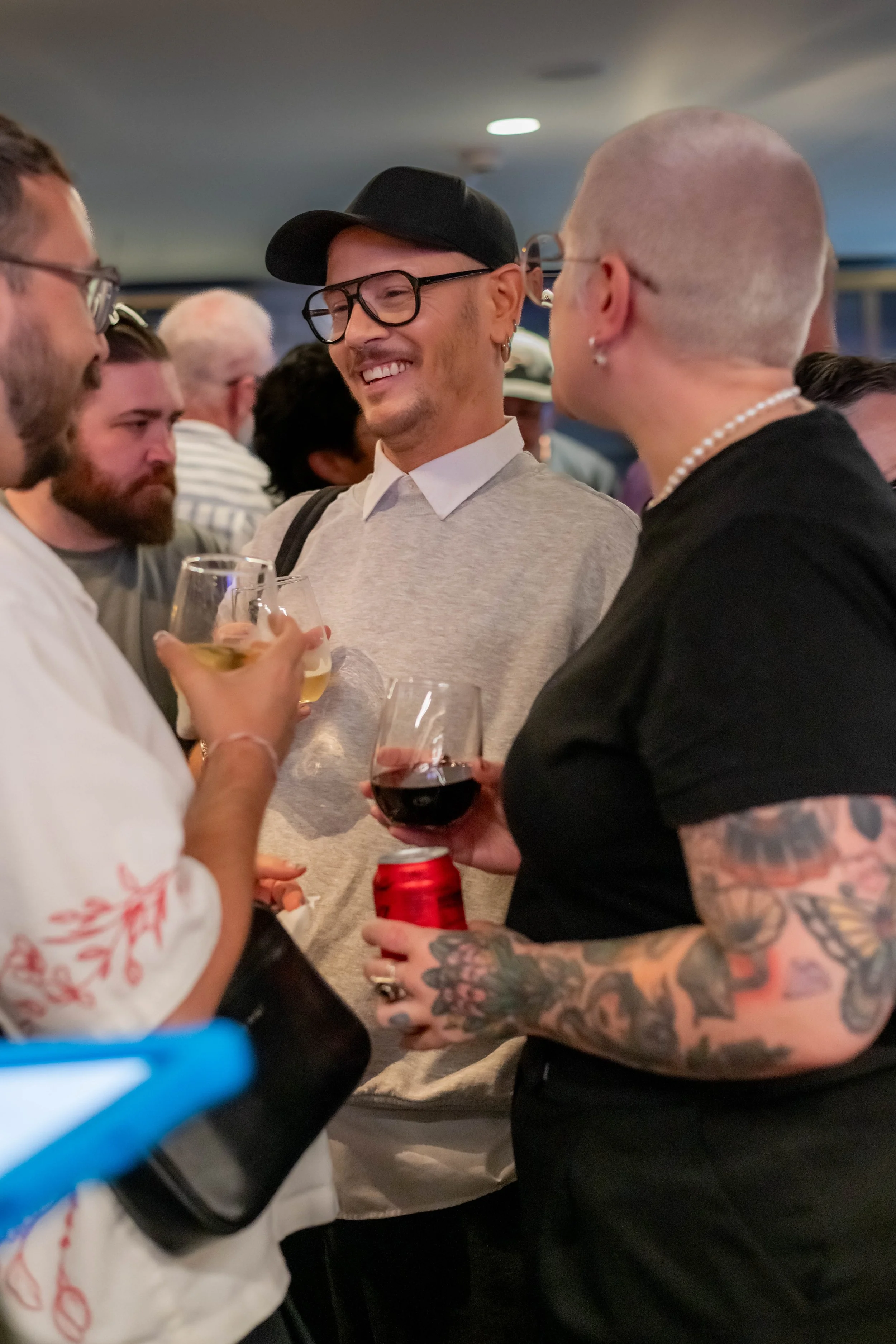 Three humans smile and chat with each other.