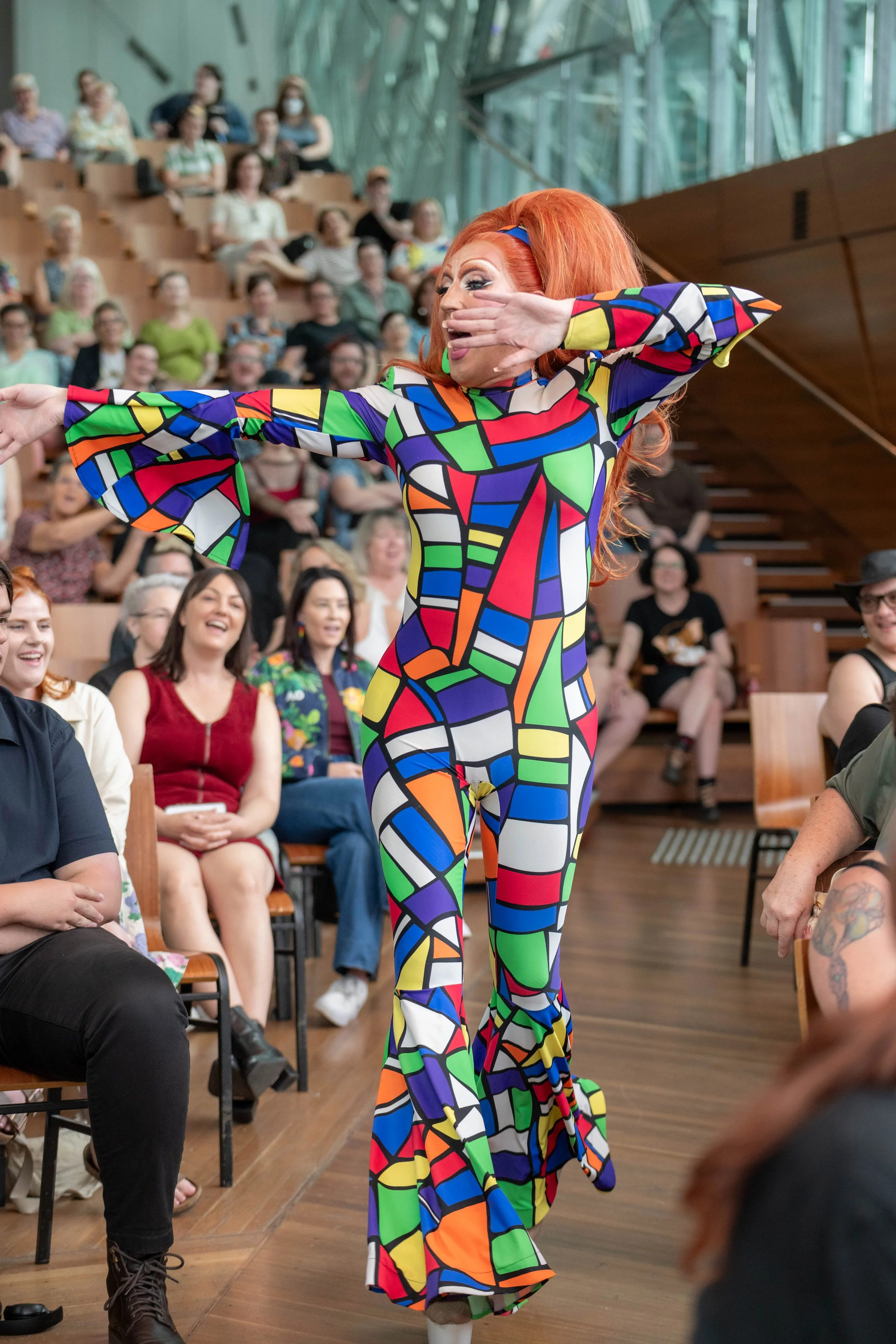 Poly Filla dances down the aisle amongst the audience.