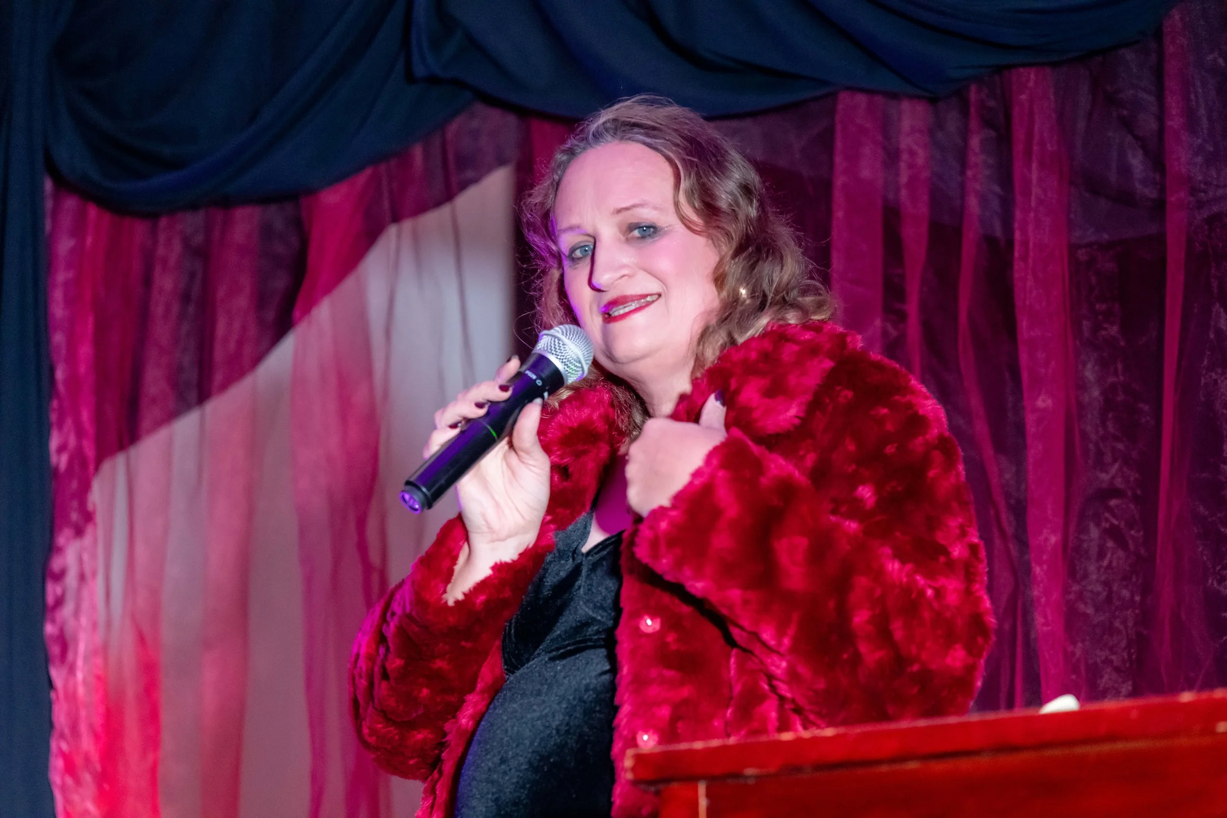 Nikki Viveca speaks into a microphone.
