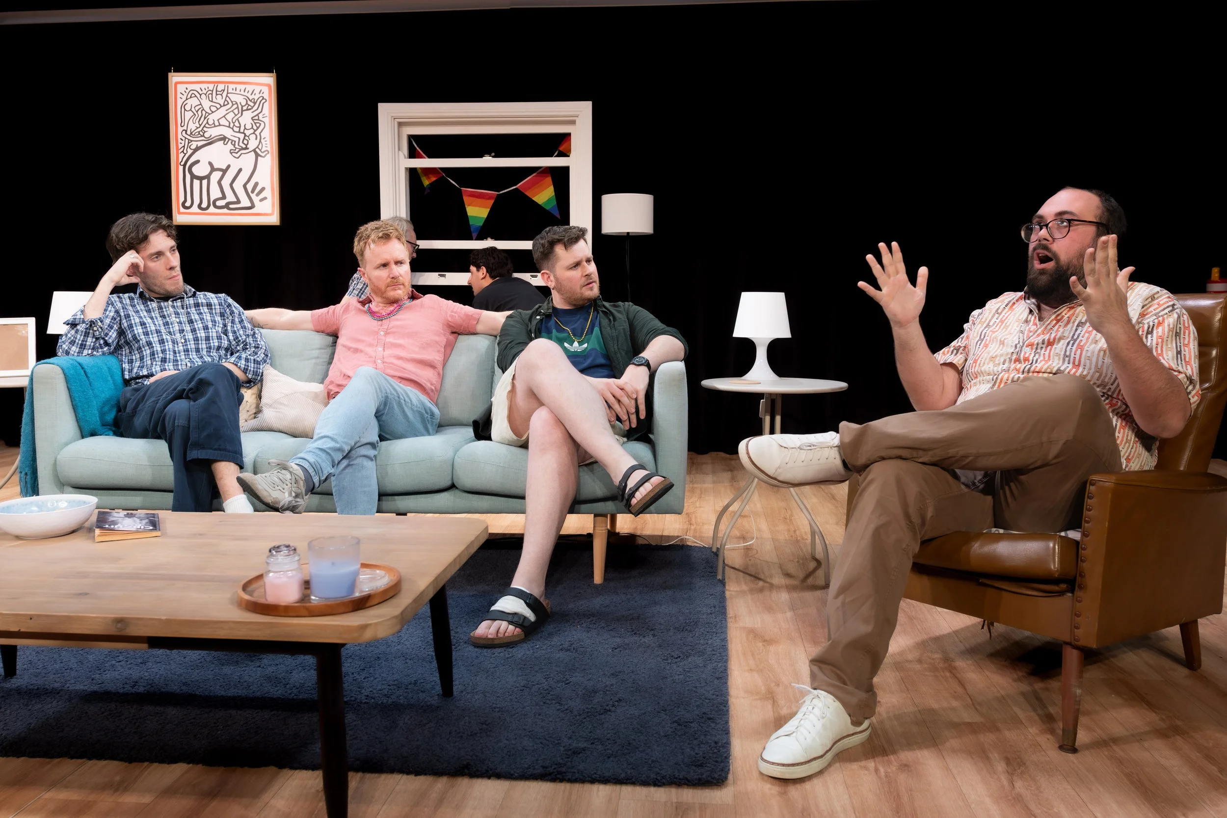 A human gesticulates as three others look on.