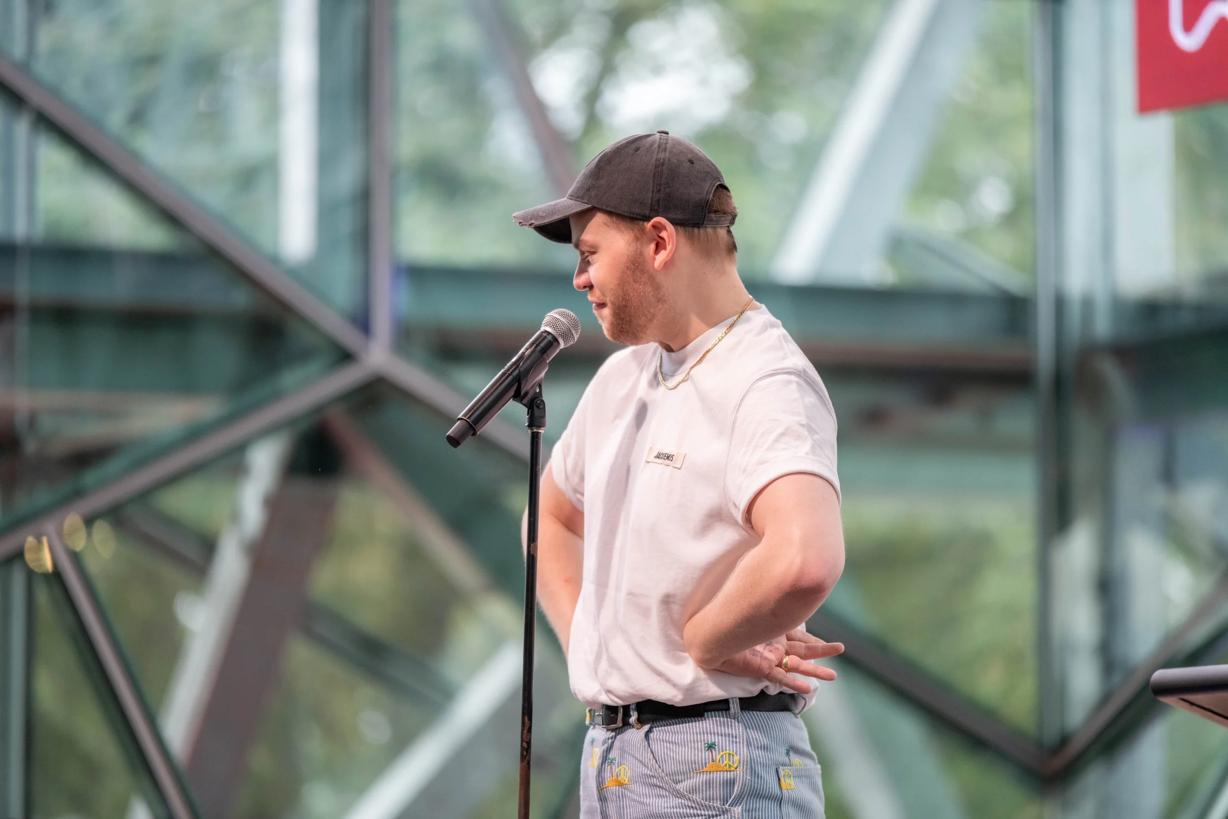 Joel Creasey has their hands on their hips.