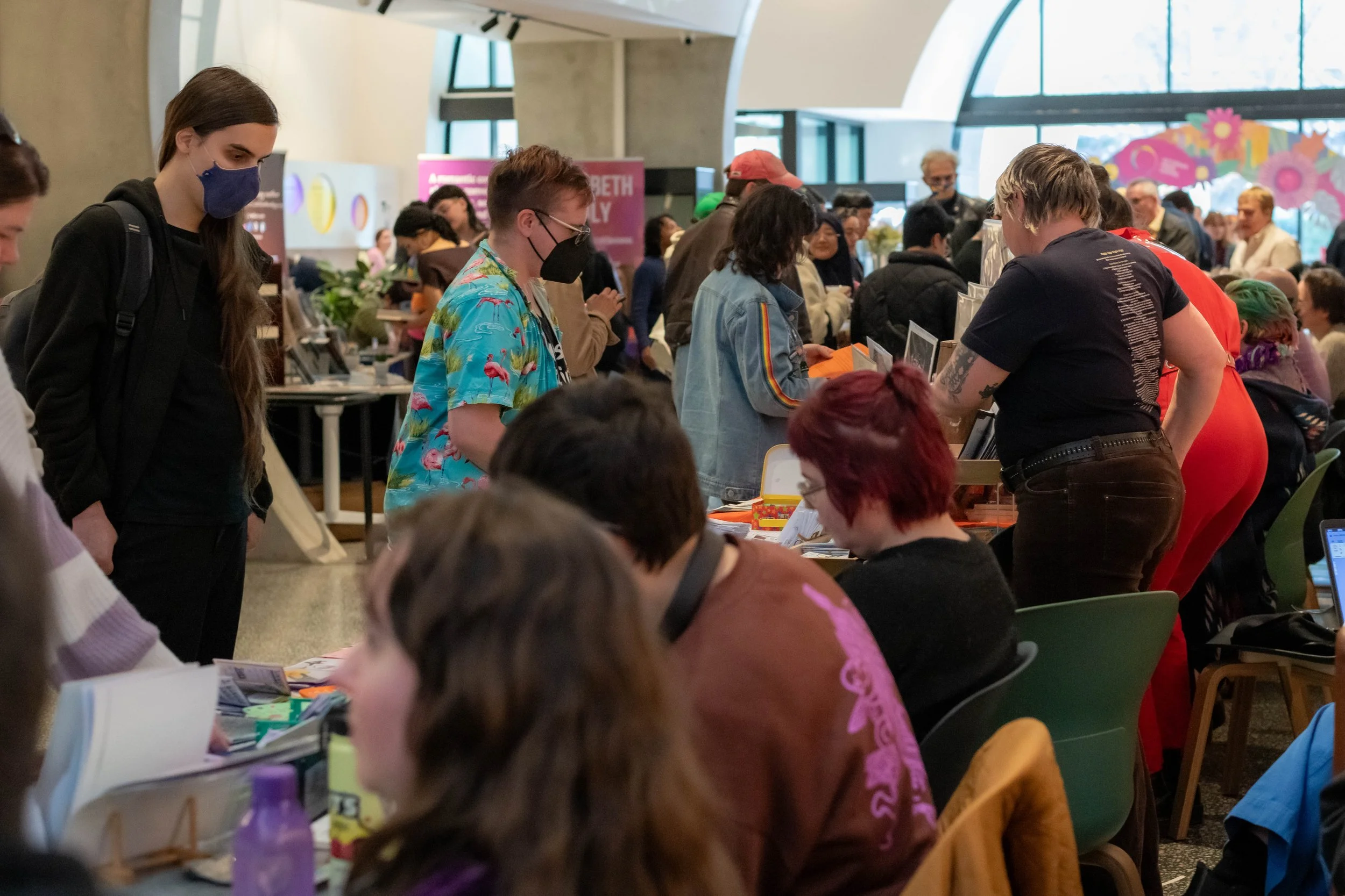 A large crowd of humans perusing book stalls.
