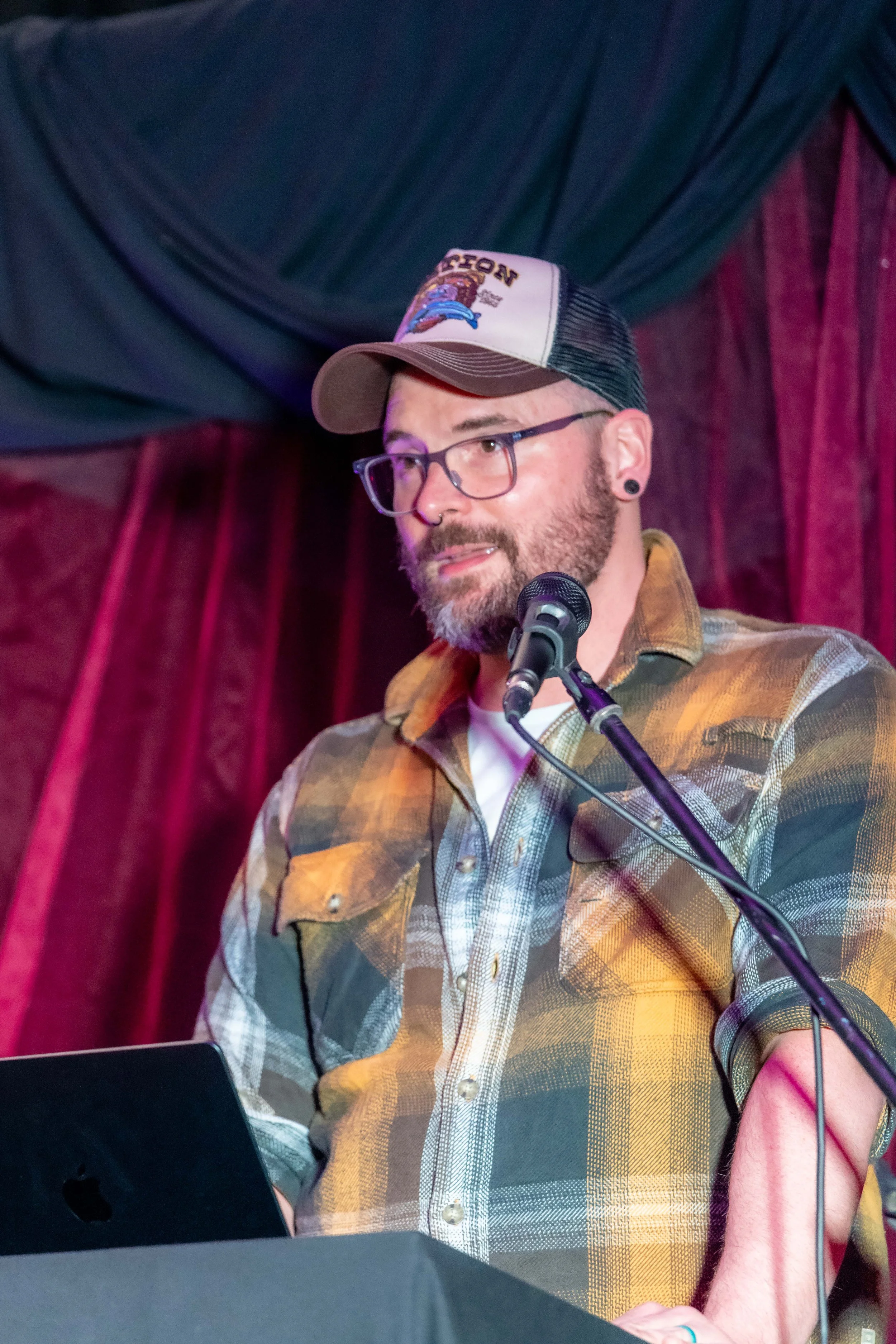 Dylan Drakes speaks into a microphone.