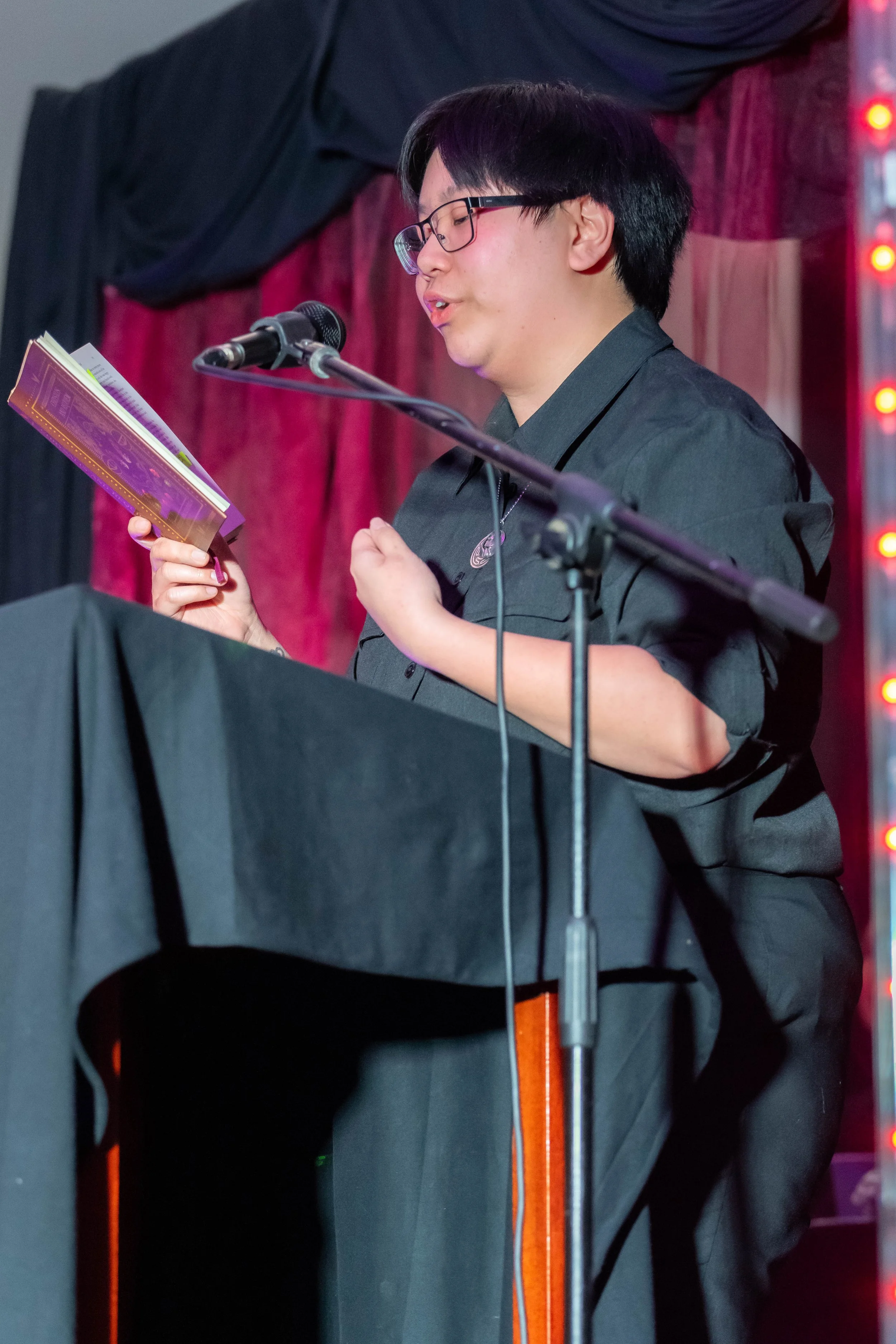 Quiton Li reads from a book.