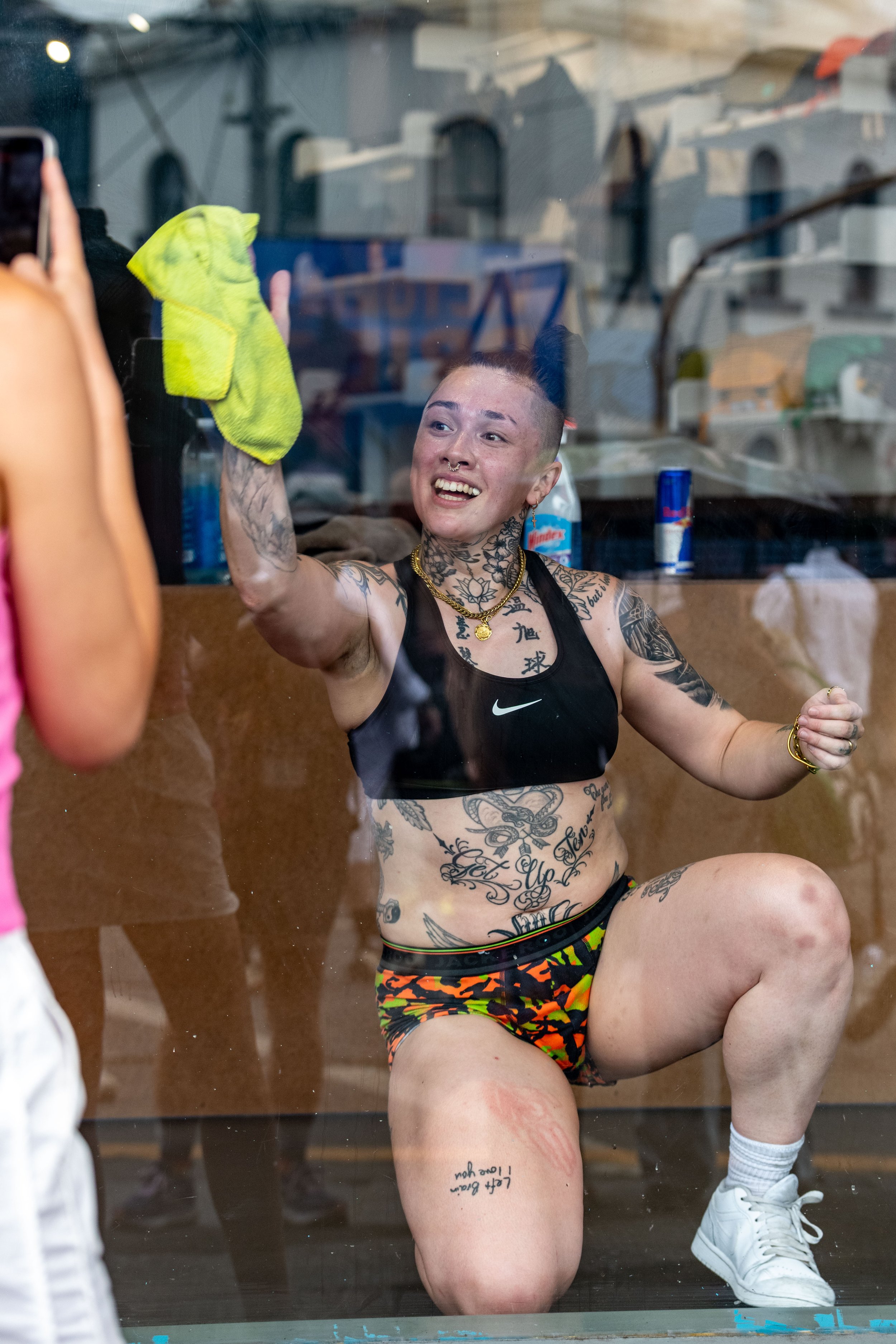 Daddy Charles cleans behind a glass window.