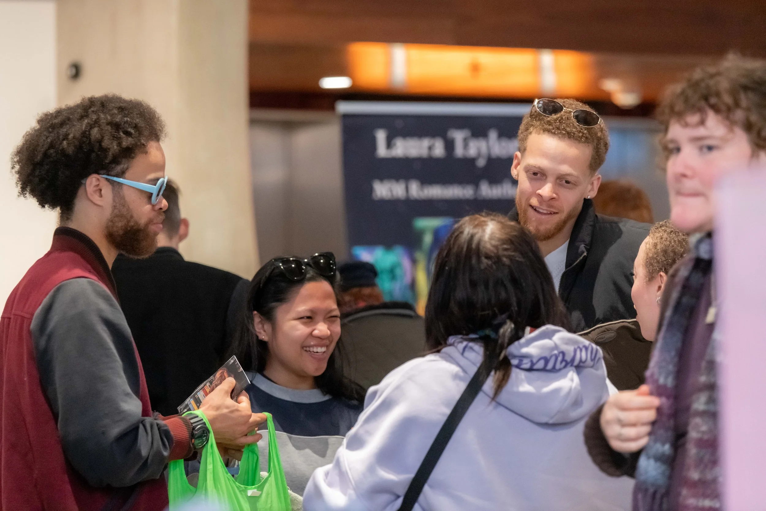 A group of humans stand and chat.