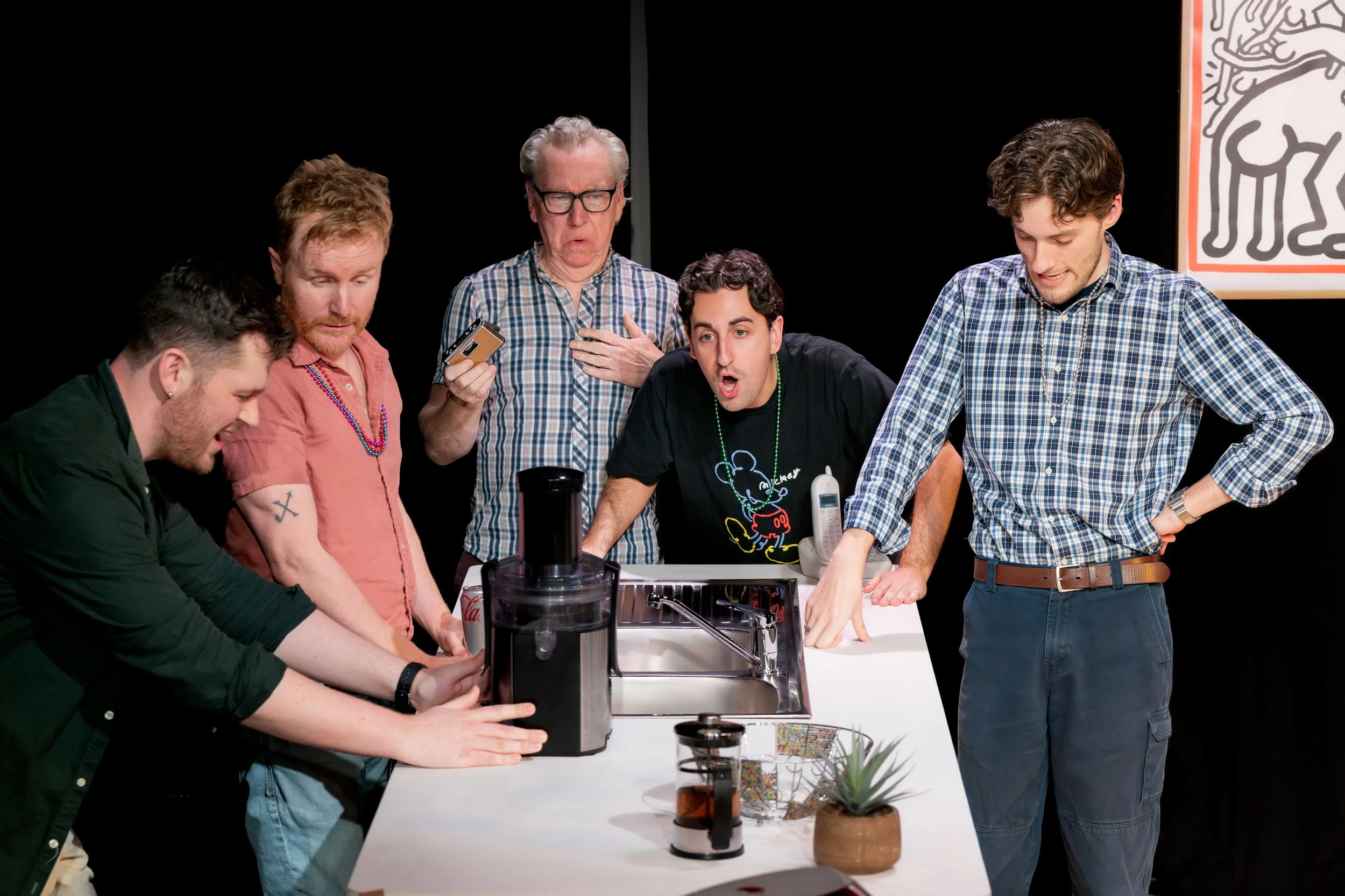 Five humans stand around a blender.