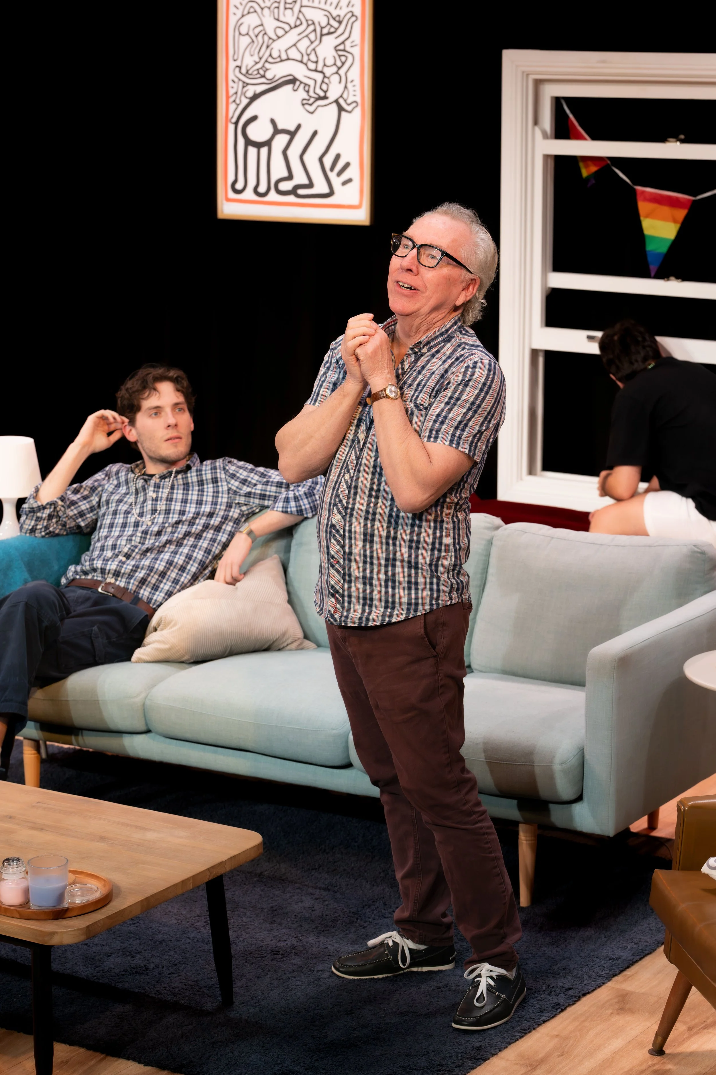 A human stands and clasps their hands.