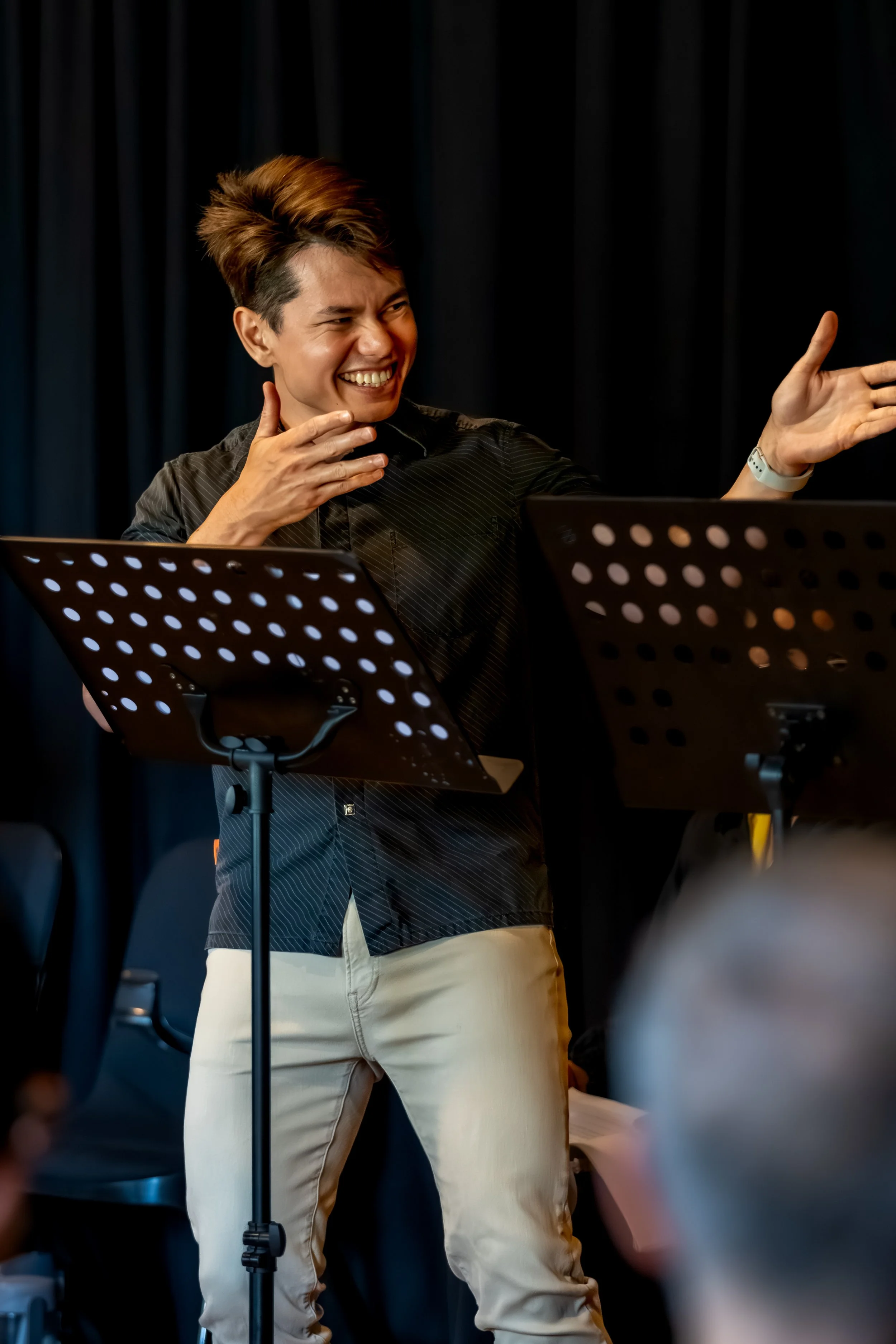 A human laughs and gesticulates with their hands.