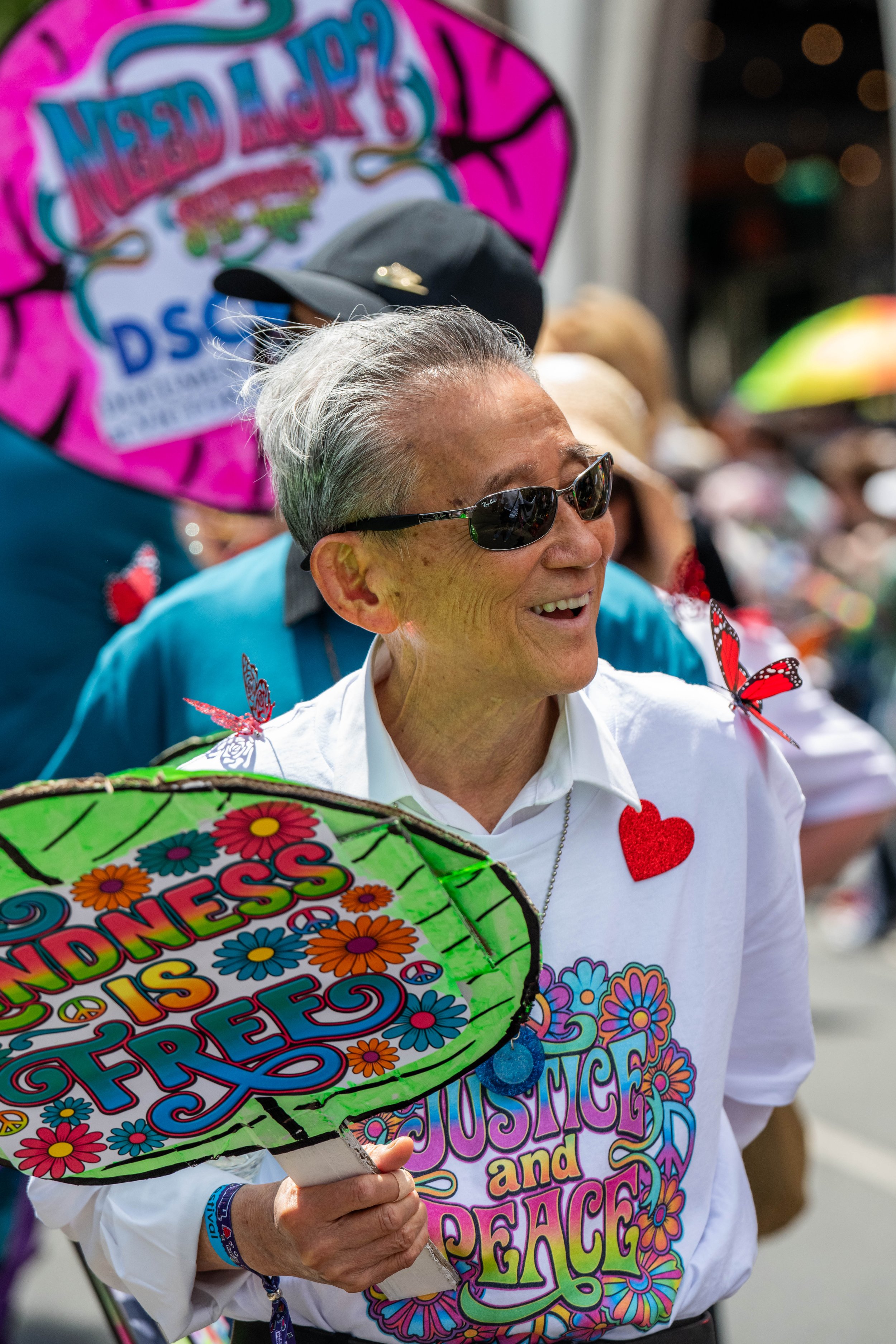 A Justice of the Peace holds a sign "Kindness is free".