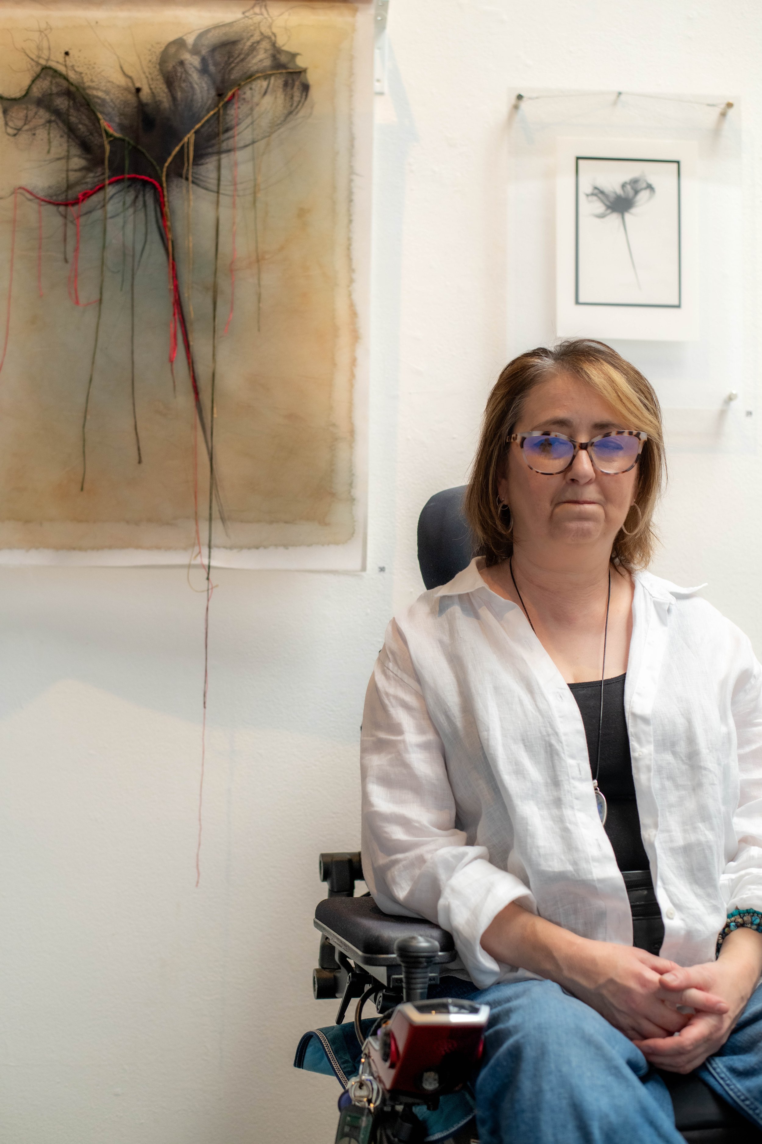 Helen Henwood next to one of their tapestry paintings.
