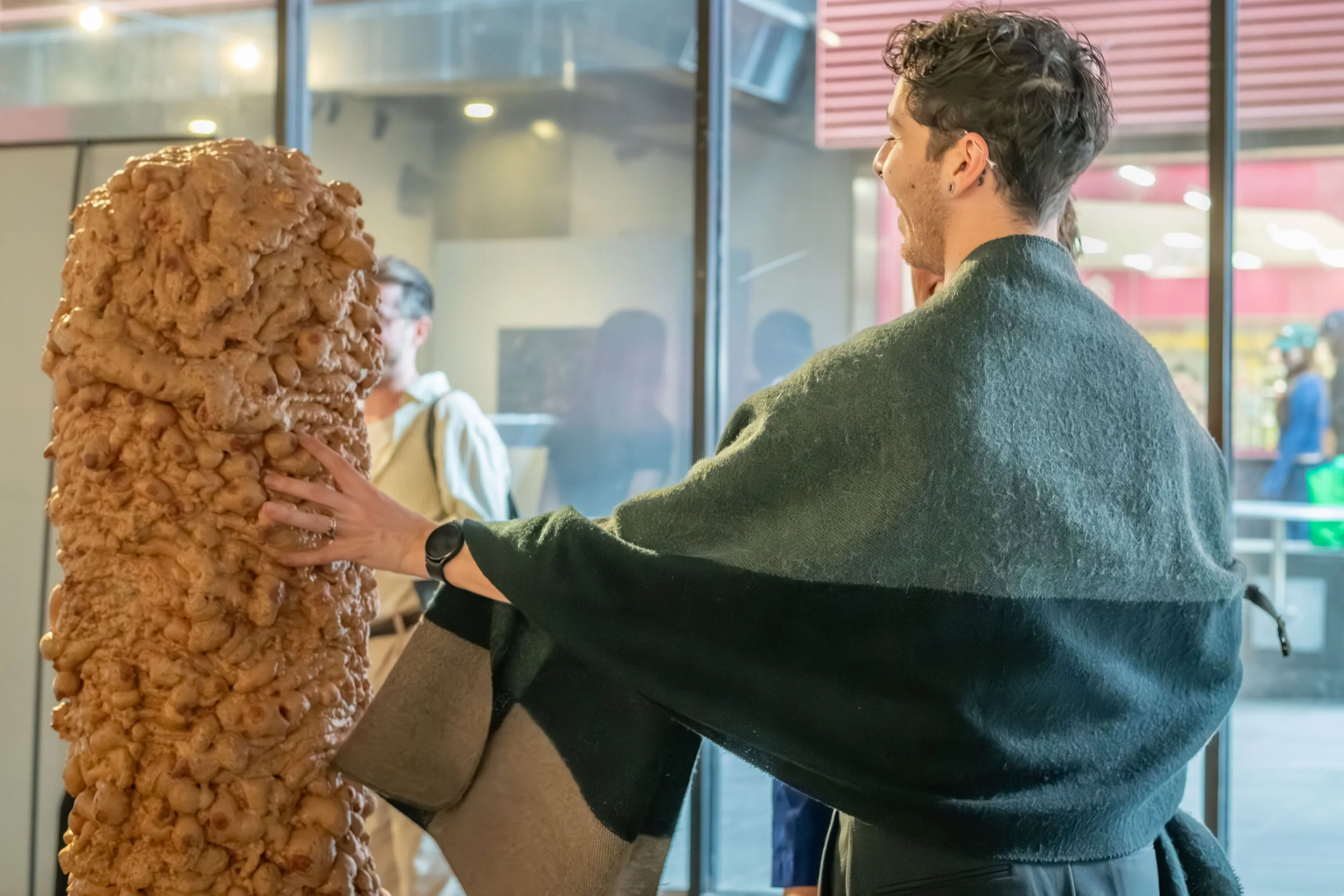 A human pushing over an artwork.