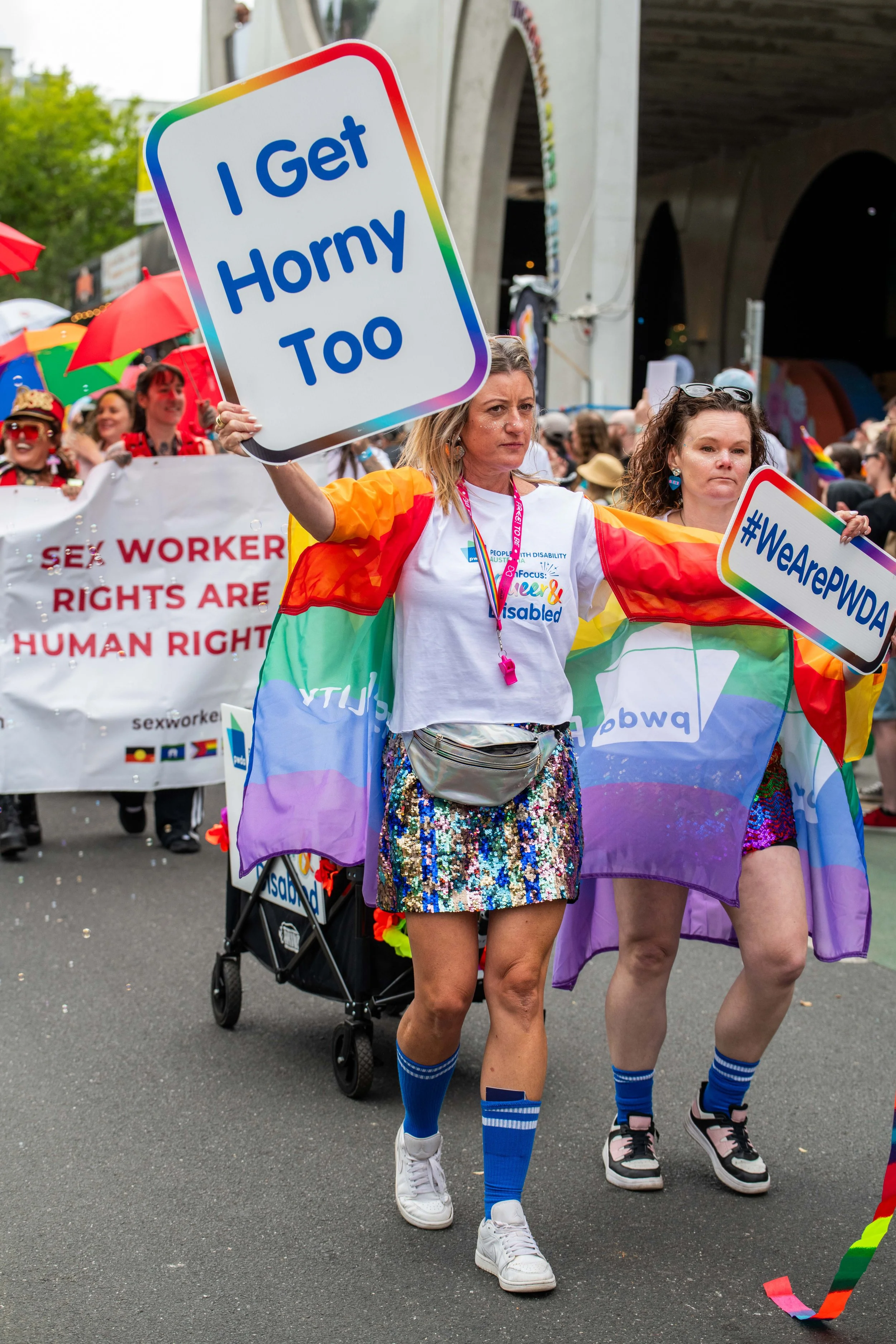A human waving a placard "I get horny too".