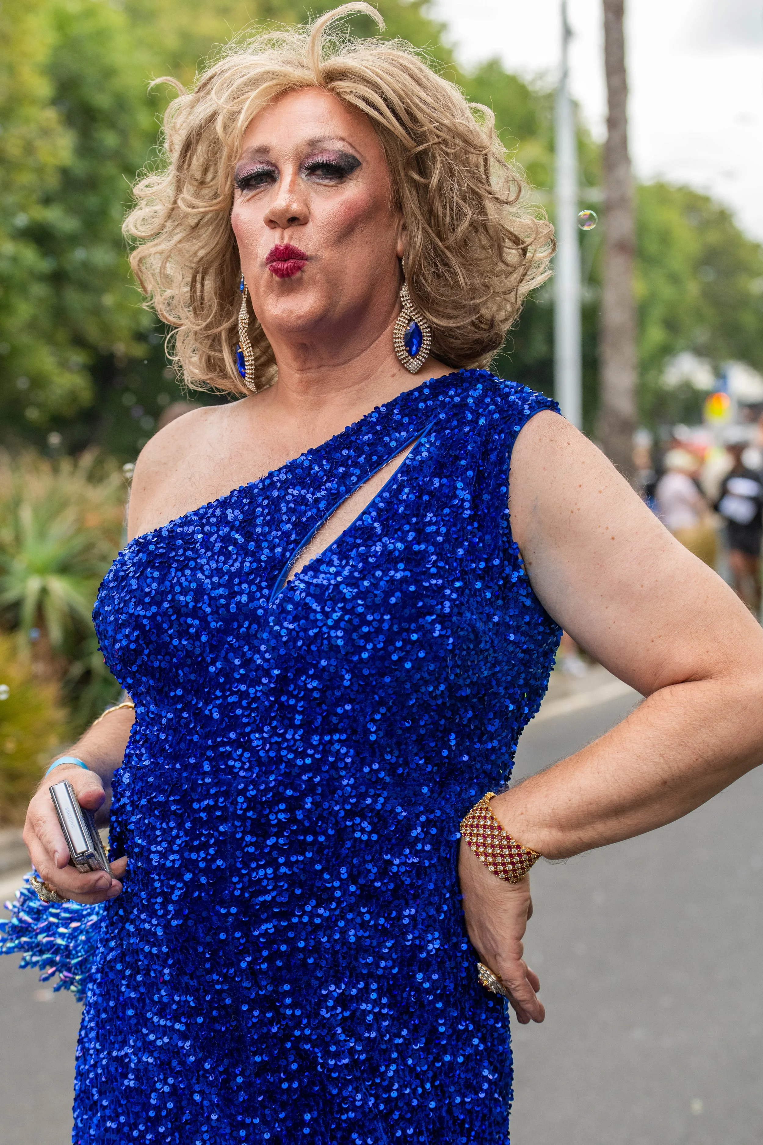 A human in a blue glittery slinky dress.