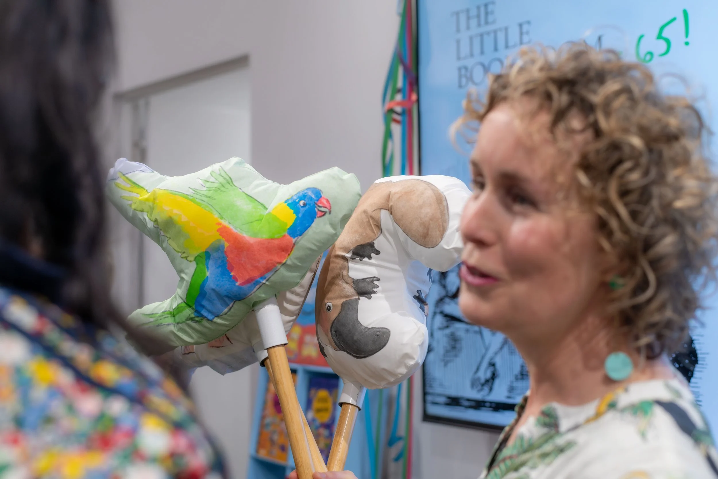 An author holds Australian wildlife puppets.