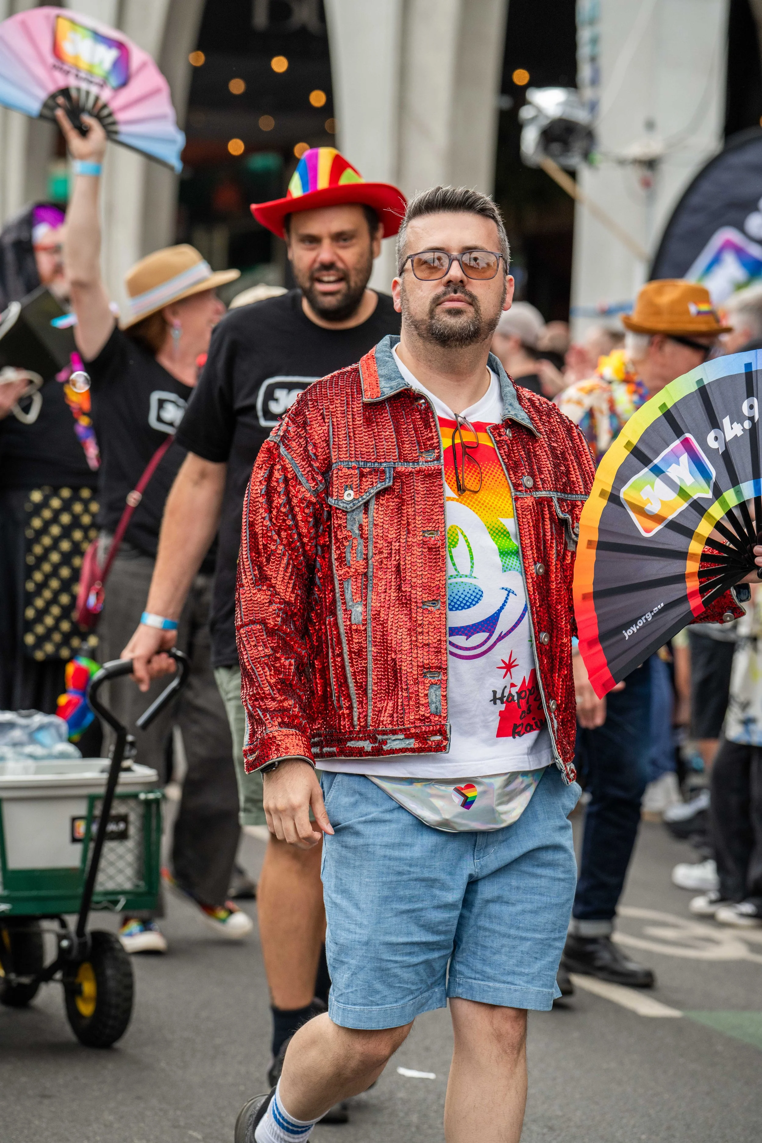 A human marching in a red glittery jacket.