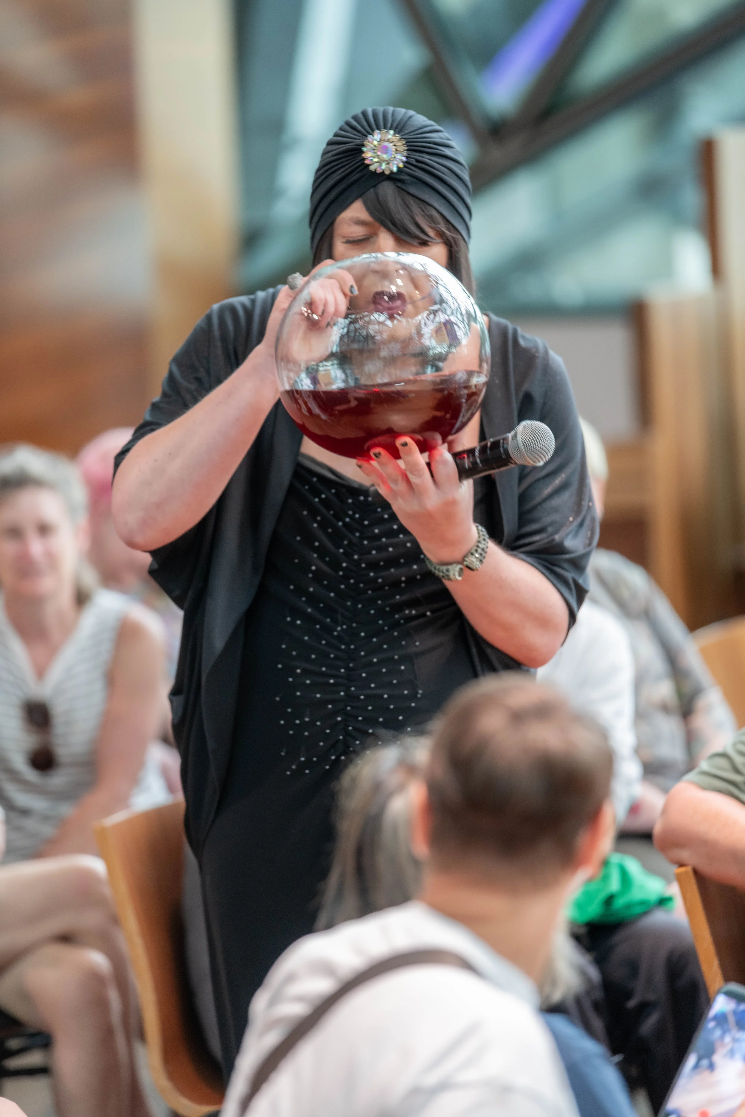 Tina Del Twist drinks from a large goldfish bowl.