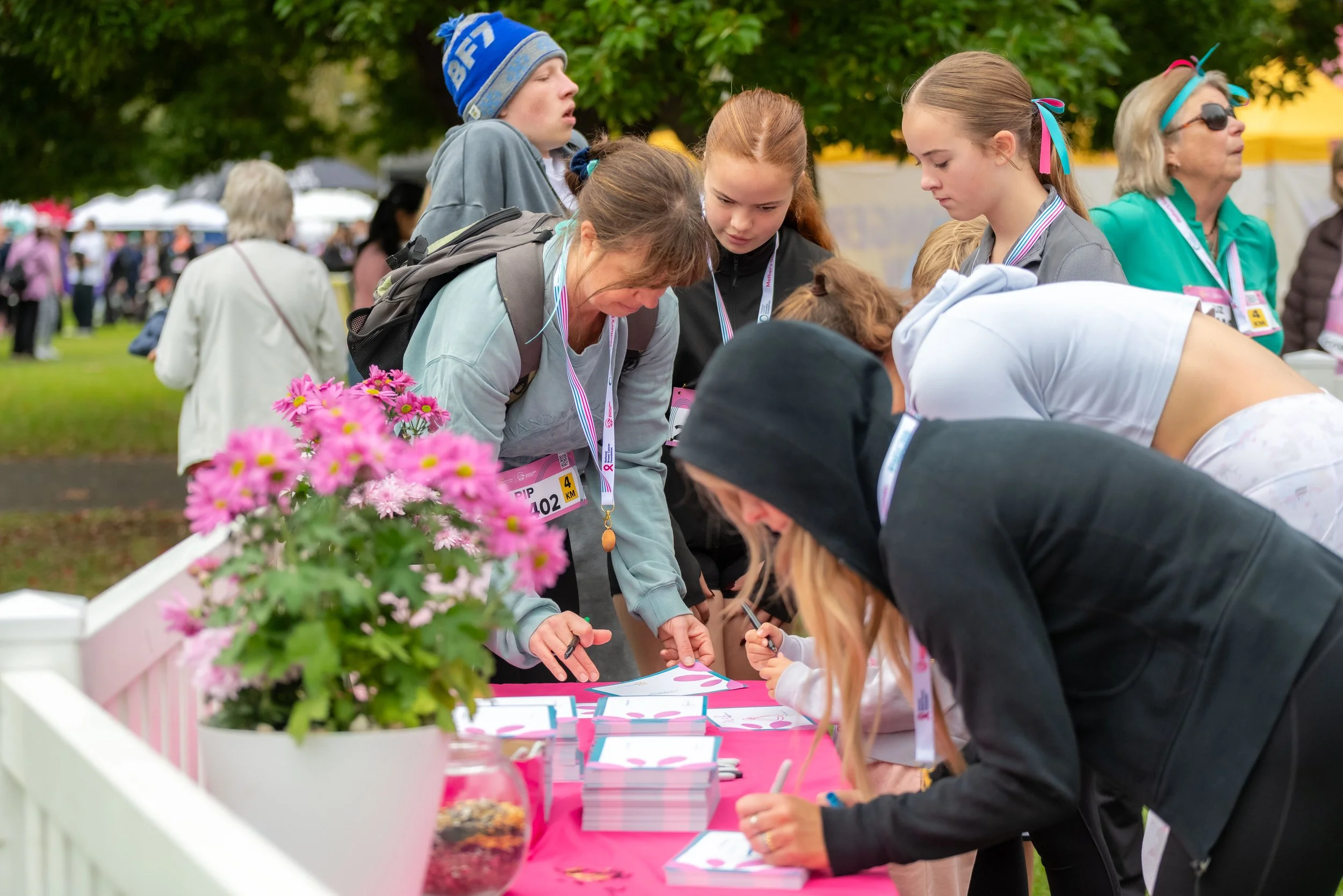 Racegoers writing notes for the tribute wall.