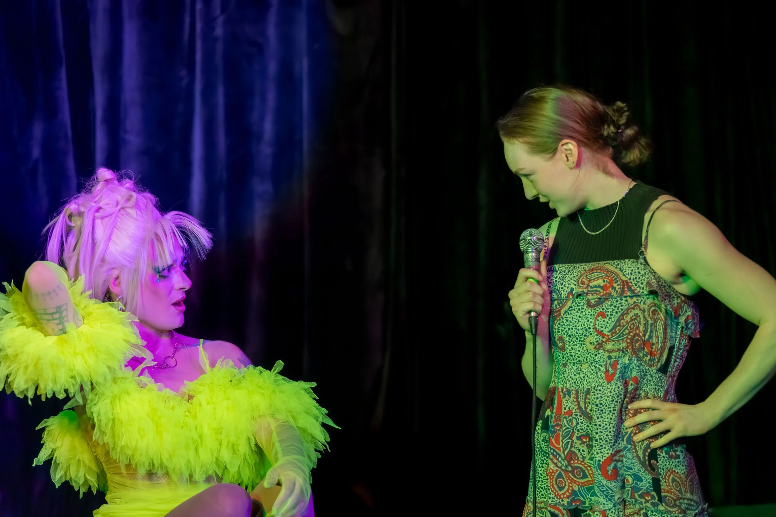 Mora Money looks at an audience member as they look back.