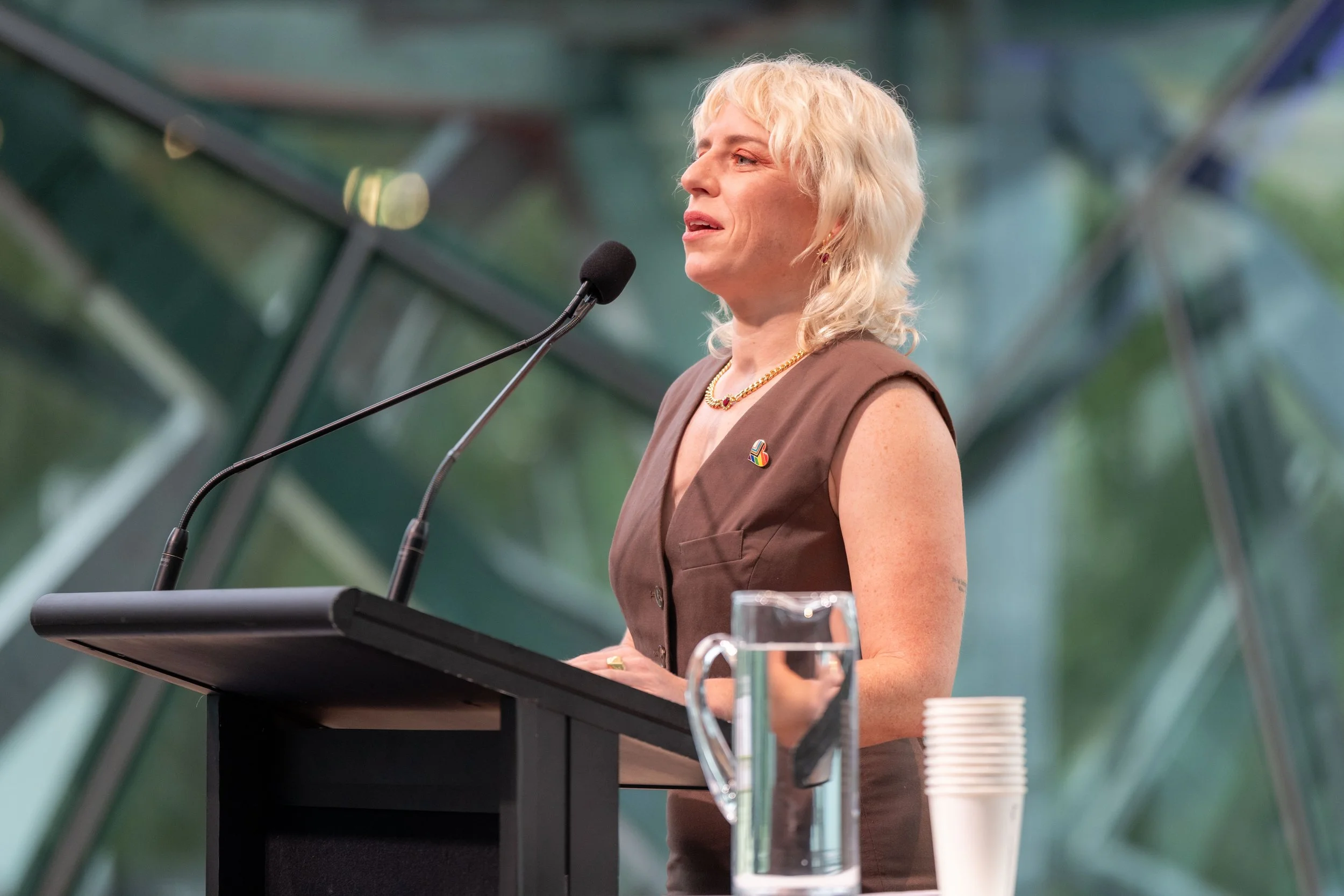 Renee Thompson stands at a lecturn and speaks into a microphone.
