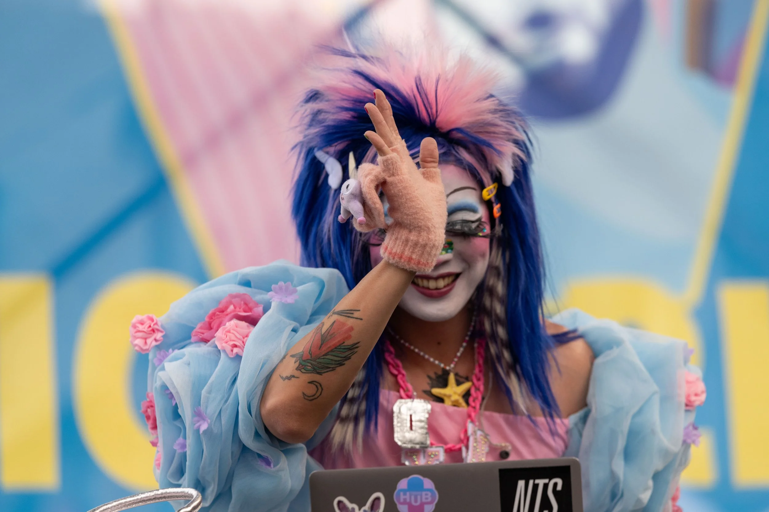 Dyan Tai smiles and waves at the audience.