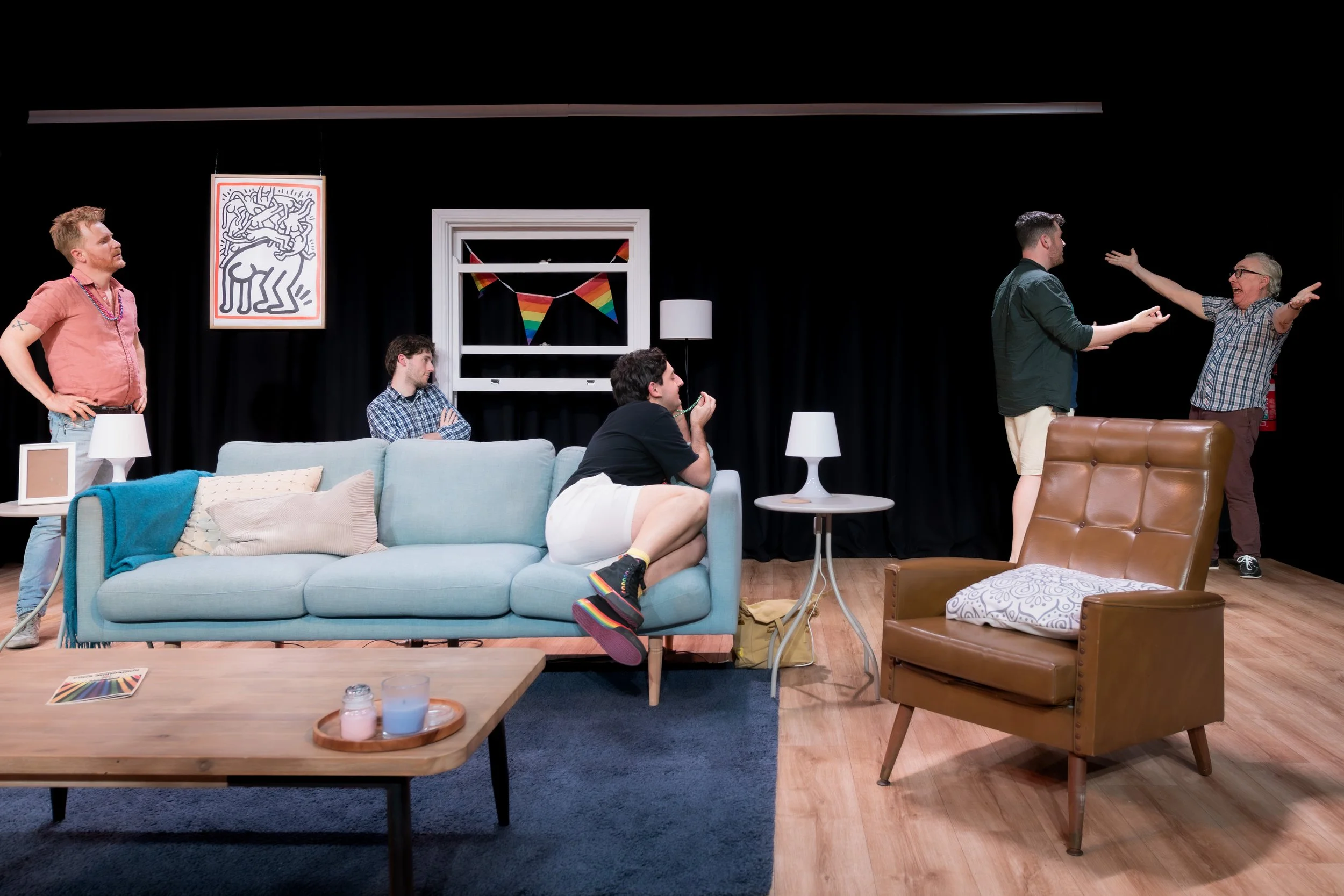 Two humans go to hug as three humans look on.