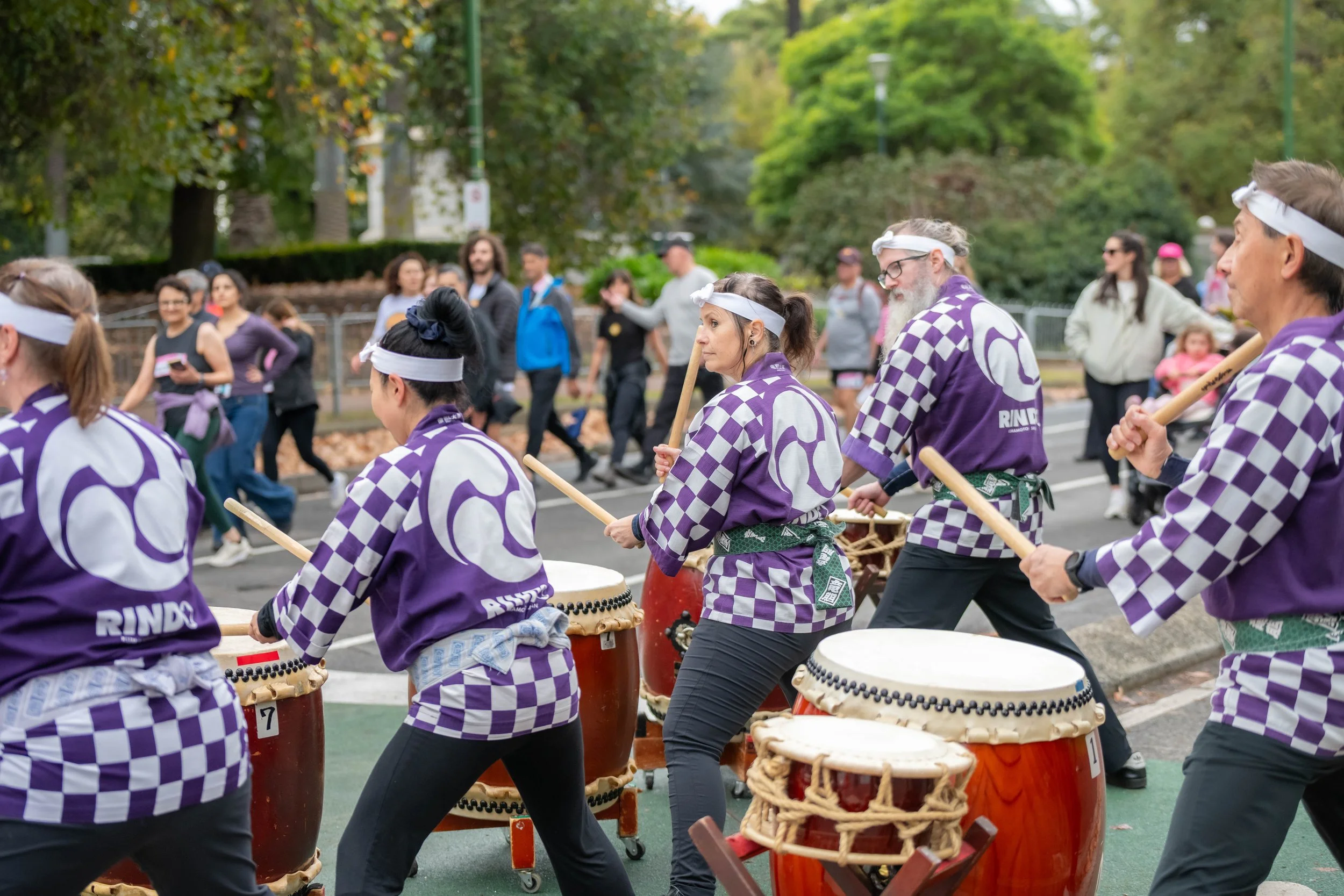 Japanese drummers playing for passing racegoers.